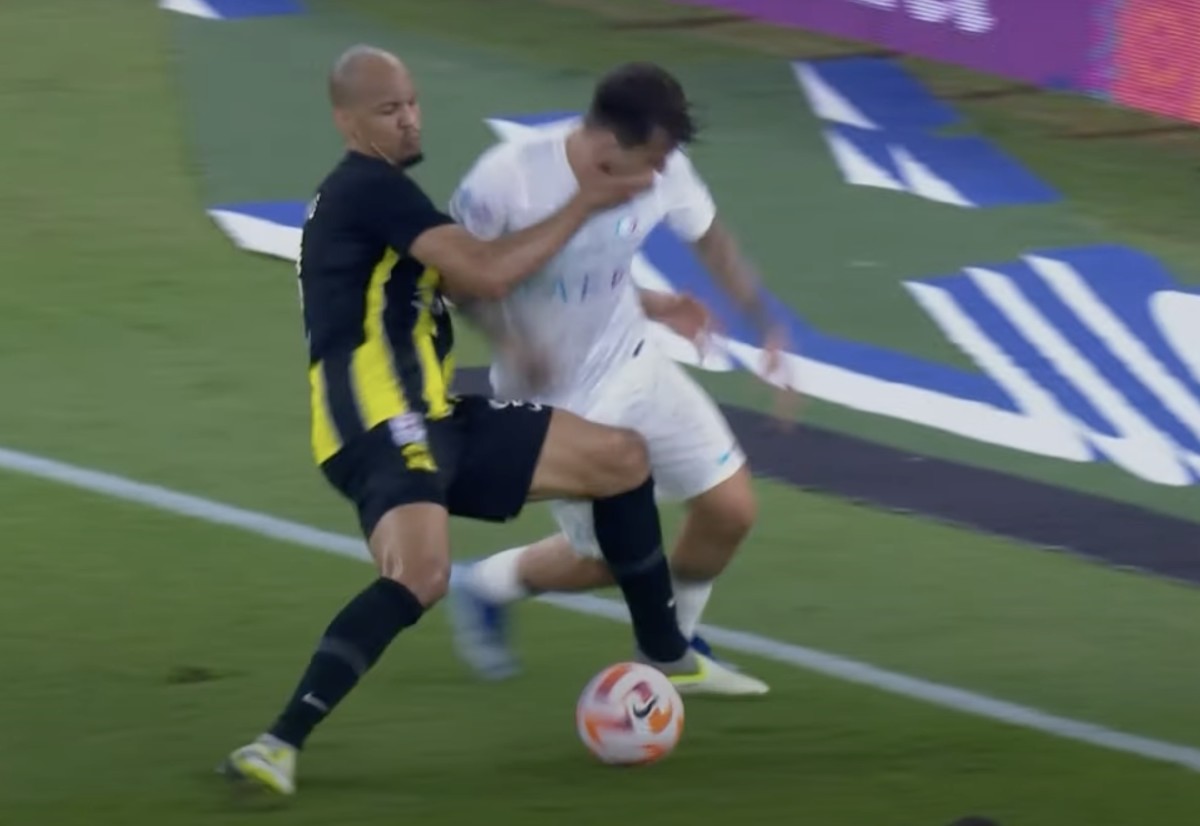 Al-Ittihad midfielder Fabinho pictured (left) striking Al Nassr's Otavio in the face with his right hand during a Saudi Pro League game in December 2023 - Fabinho was sent off following a VAR review