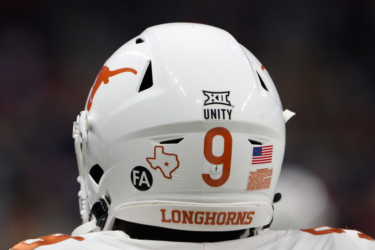 Dec 29, 2020; San Antonio, TX, USA; Detailed view of the \"Unity\" and \"FA\" to honor former coach Fred Akers, who died on Dec. 7 on the back of the helmet of Texas Longhorns wide receiver Al'Vonte Woodard (9) during the Alamo Bowl against the Colorado Buffaloes at the Alamodome. Texas defeated Colorado 55-23. Mandatory Credit: Kirby Lee-USA TODAY Sports