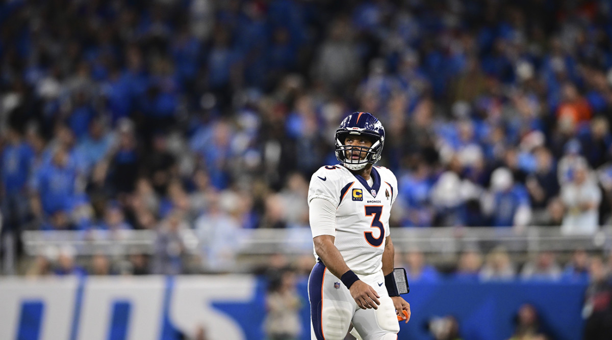 Denver Broncos quarterback Russell Wilson walks off the field during the first half of an NFL football game against the Detroit Lions.