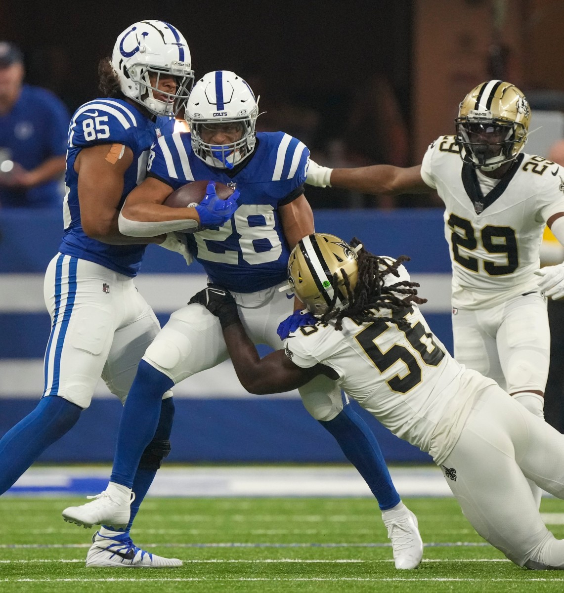 Indianapolis Colts running back Jonathan Taylor (28) is brought down by New Orleans Saints linebacker Demario Davis (56). © Robert Scheer/IndyStar / USA TODAY NETWORK