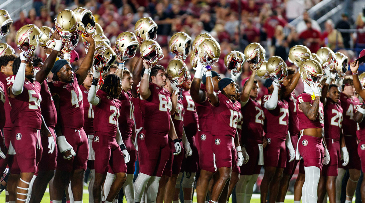 Florida State football players salute crowd at Doak S. Campbell Stadium in Tallahassee, Florida.