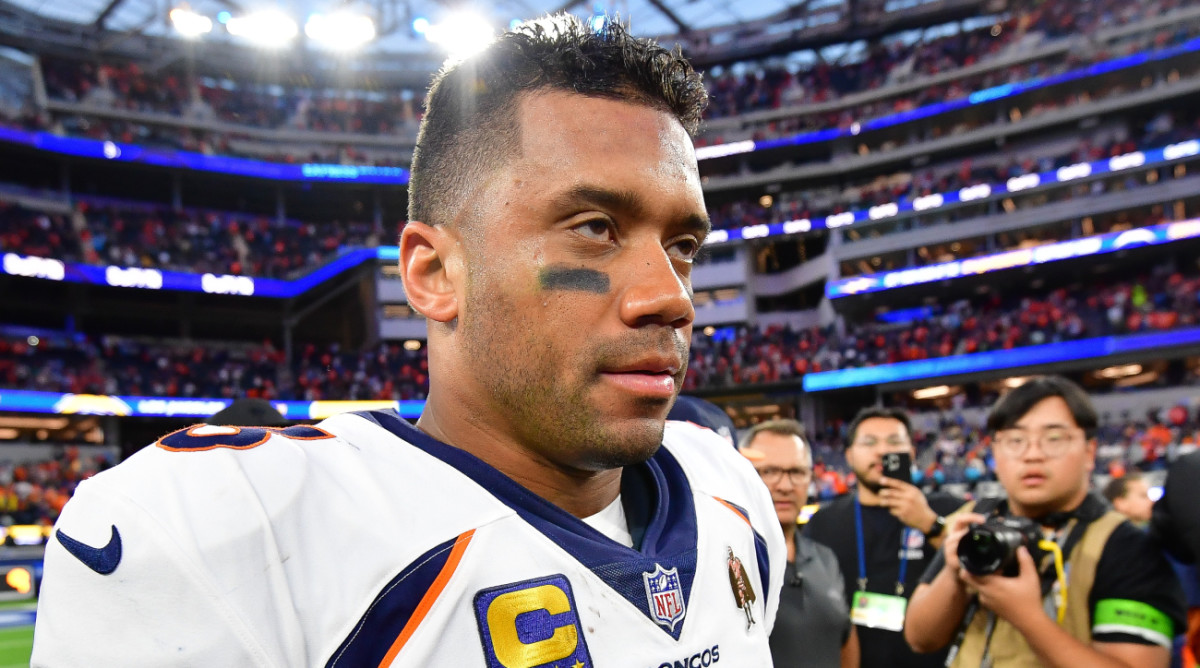 Broncos quarterback Russell Wilson walks off the field after a win.