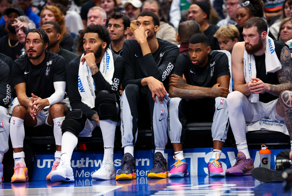 Dec 23, 2023; Dallas, Texas, USA; San Antonio Spurs center Victor Wembanyama (1) sits on the bench with teammates during the second quarter against the Dallas Mavericks at American Airlines Center.