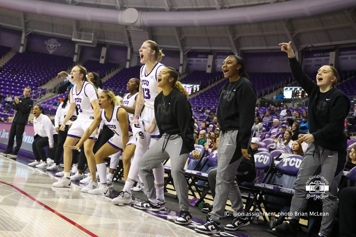 TCU's bench, including starters (left to right) Madison Conner (3), Jaden Owens (1), and Sedona Prince (13), celebrates a made shot against Omaha.