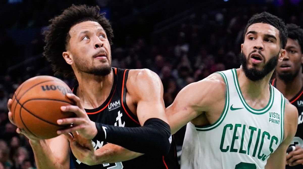 Pistons guard Cade Cunningham attempts to shoot a basket against Celtics forward Jayson Tatum.