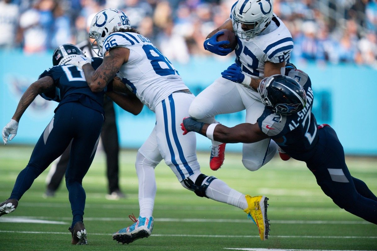 Indianapolis Colts tight end Kylen Granson (83) is brought down by Tennessee Titans linebacker Azeez Al-Shaair (2) during their game at Nissan Stadium in Nashville, Tenn., Sunday, Dec. 3, 2023.