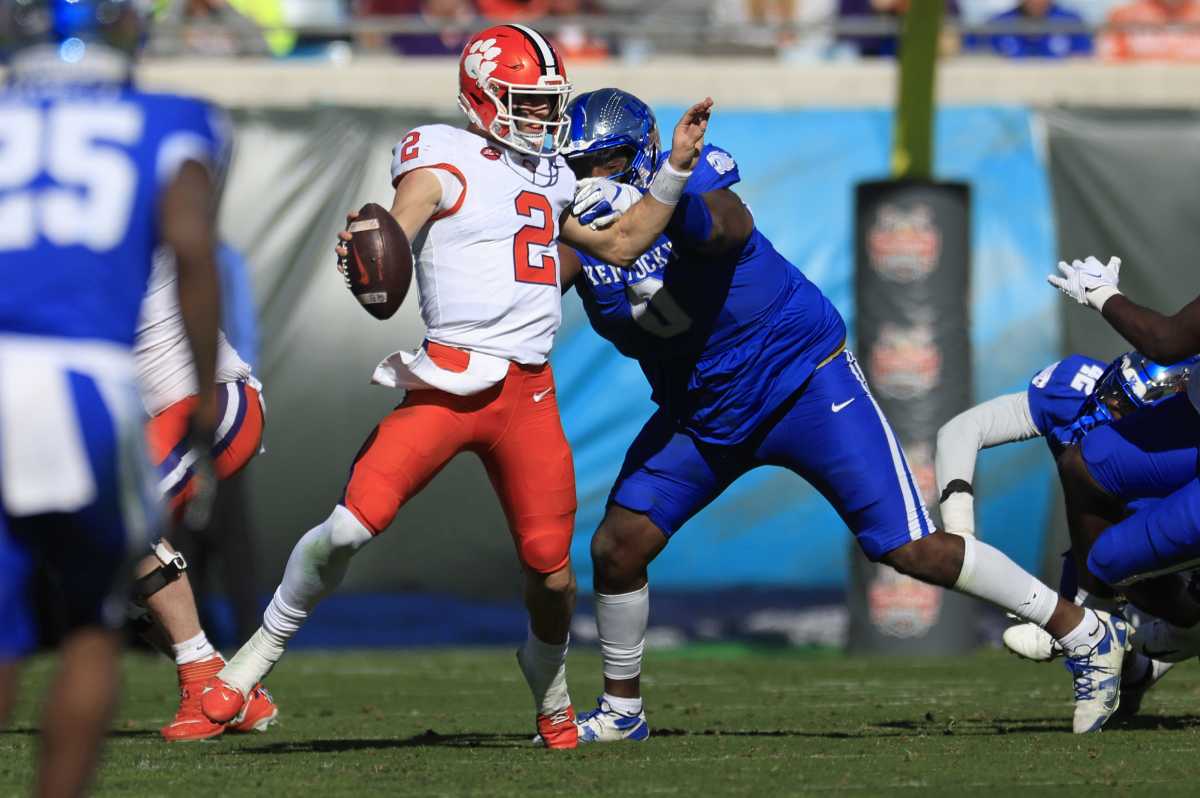 Kentucky Wildcats defensive lineman Deone Walker (0) sacks Clemson Tigers quarterback Cade Klubnik (2) during the second quarter of an NCAA football matchup in the TaxSlayer Gator Bowl Friday, Dec. 29, 2023 at EverBank Stadium in Jacksonville, Fla. [Corey Perrine/Florida Times-Union]