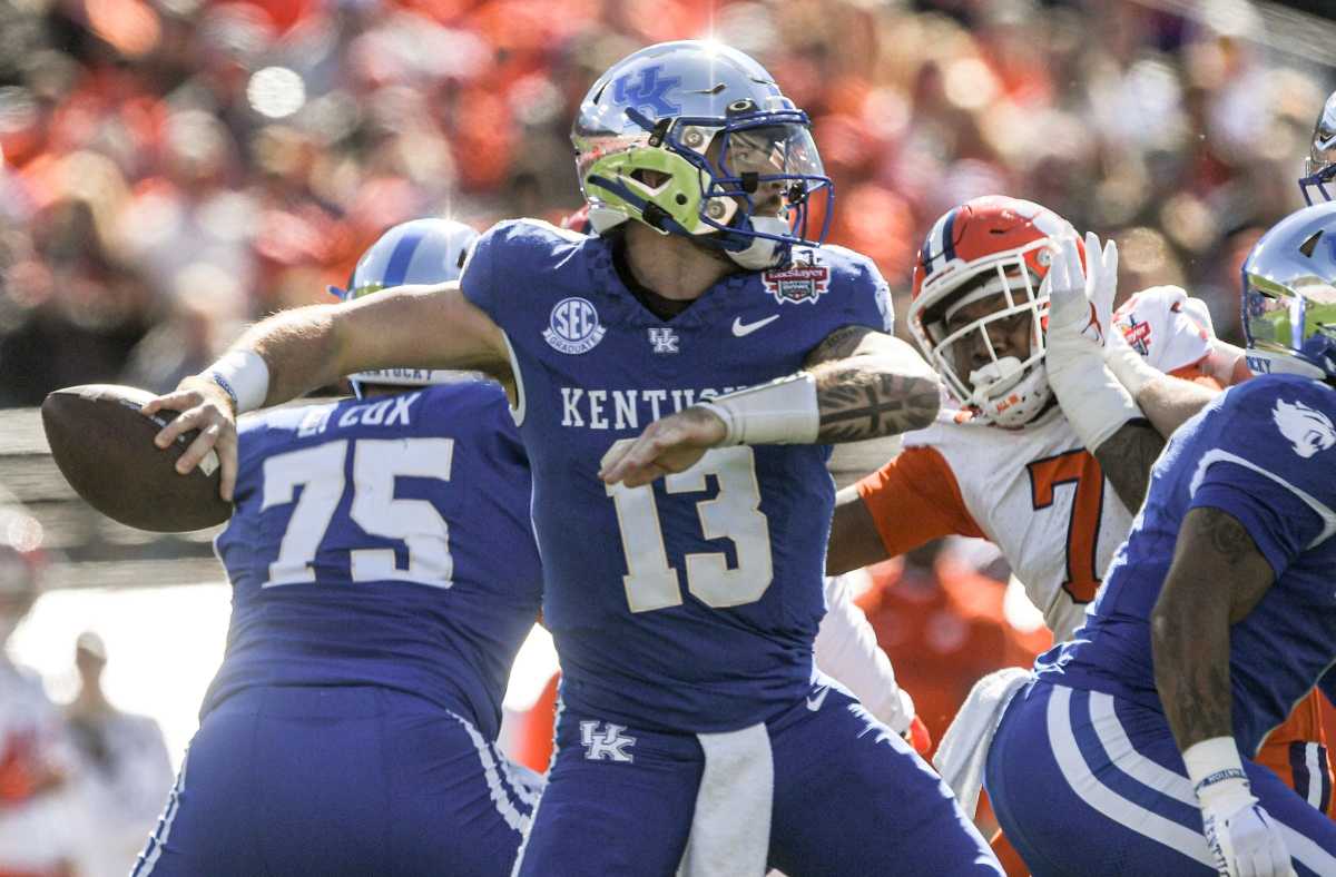 Kentucky quarterback Devin Leary (13) passes near Clemson defensive end Justin Mascoll (7) during the first quarter of the TaxSlayer Gator Bowl at EverBank Stadium in Jacksonville Beach, Florida, Friday, December 29, 2023.