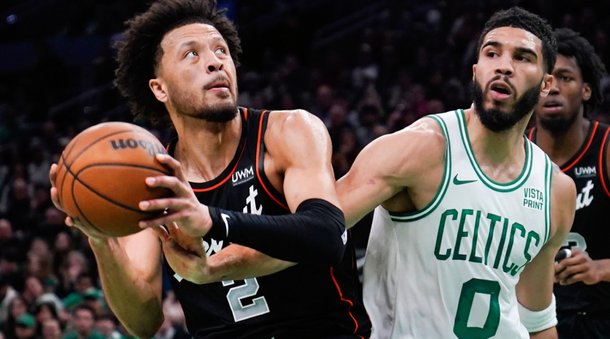 Detroit Pistons guard Cade Cunningham (2) drives to the basket against Boston Celtics forward Jayson Tatum (0) during the first half of an NBA basketball game, Thursday, Dec. 28, 2023, in Boston. (AP Photo/Charles Krupa)