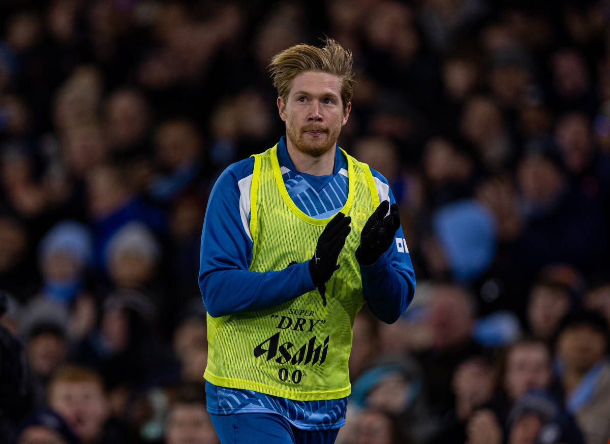 Kevin De Bruyne pictured applauding Manchester City supporters while warming up during a Premier League game against Sheffield United in December 2023