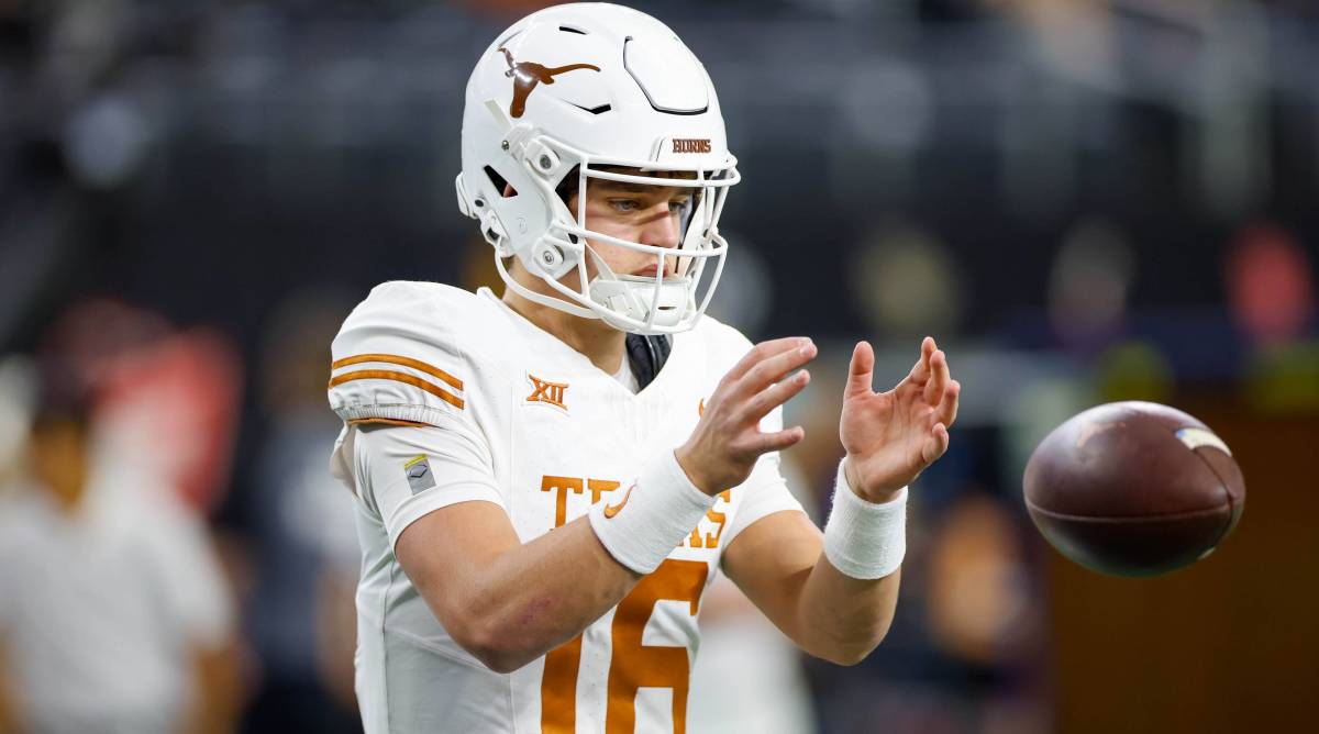 Texas quarterback Arch Manning catches a ball in warmups before a game.