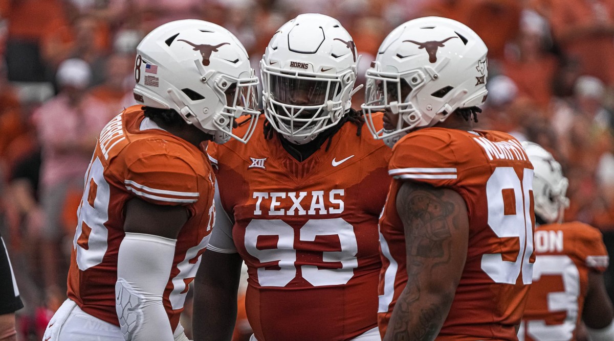 Texas Longhorns defensive lineman T'Vondre Sweat (93), center, huddles with teammates during a game against Kansas State.