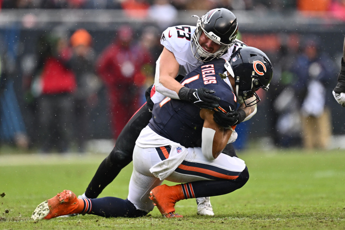 Dec 31, 2023; Chicago, Illinois, USA; Chicago Bears quarterback Justin Fields (1) is tackled by Atlanta Falcons linebacker Nate Landman (53) after a short gain in the first half at Soldier Field.
