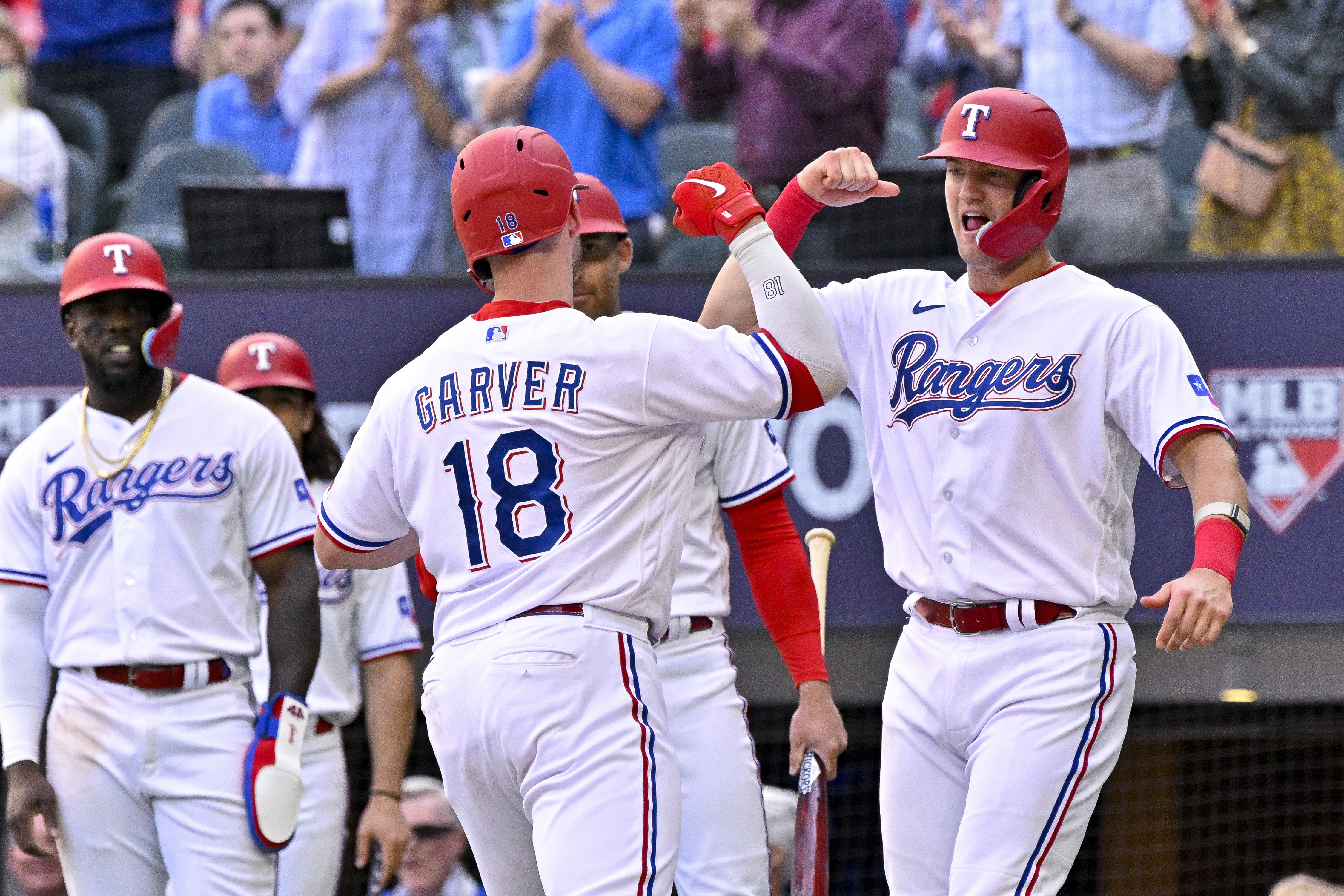 Texas Rangers catcher Mitch Garver and third baseman Josh Jung celebrate after Garver hit a three-run home run against the Philadelphia Phillies on April 1 at Globe Life Field. The Rangers outscored the defending National League champions 29-11 during a three-game, season-opening sweep.