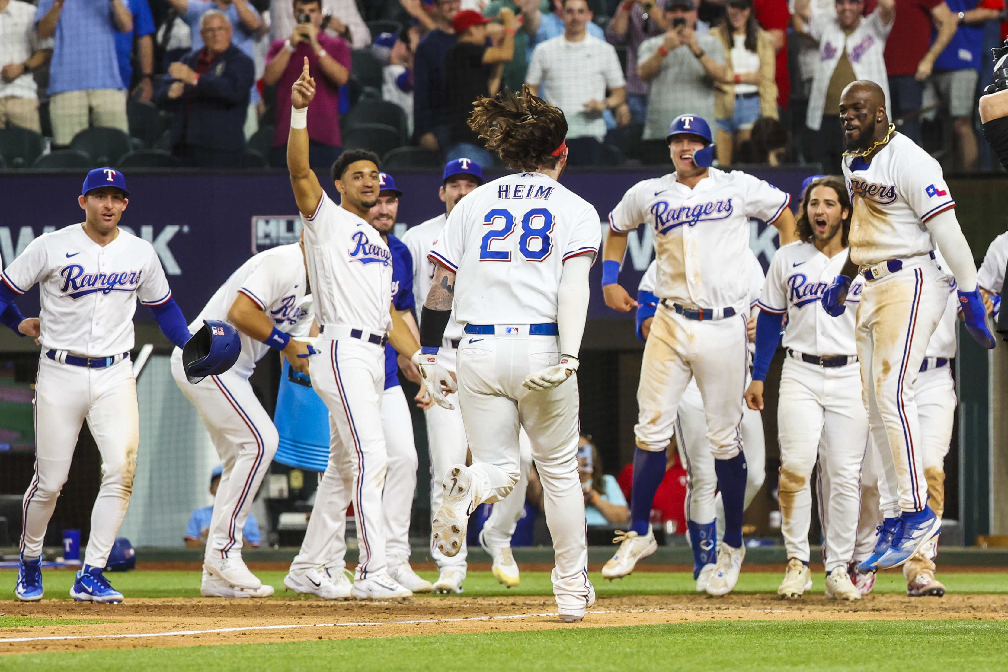 Texas Rangers catcher Jonah Heim celebrates with teammates after hitting a walk-off three-run home run during the tenth inning against the Kansas City Royals on April 11 at Globe Life Field.
