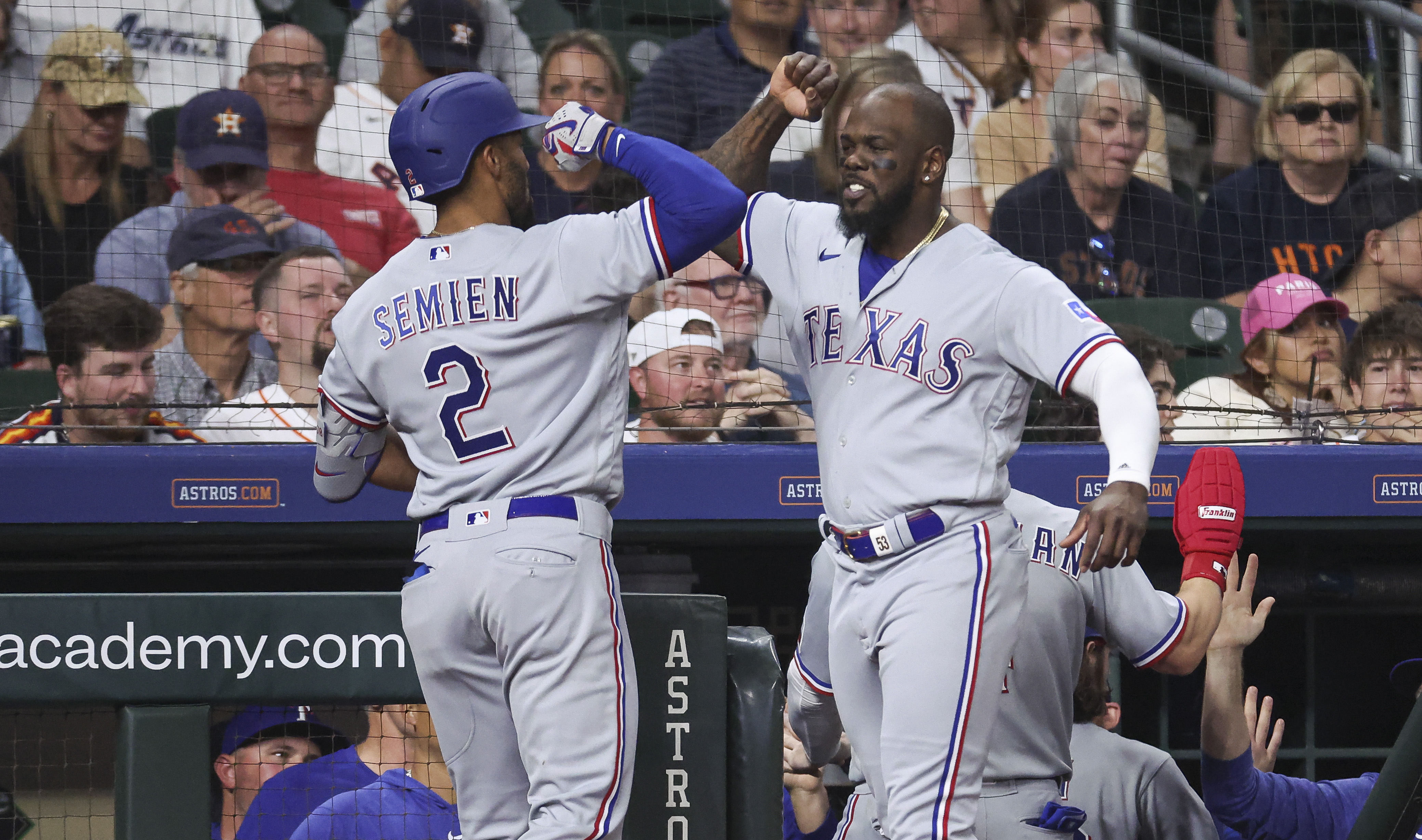 Texas Rangers second baseman Marcus Semien, left, celebrates with right fielder Adolis Garcia after hitting a grand slam in the seventh inning against the Houston Astros on April 16 at Minute Maid Park.