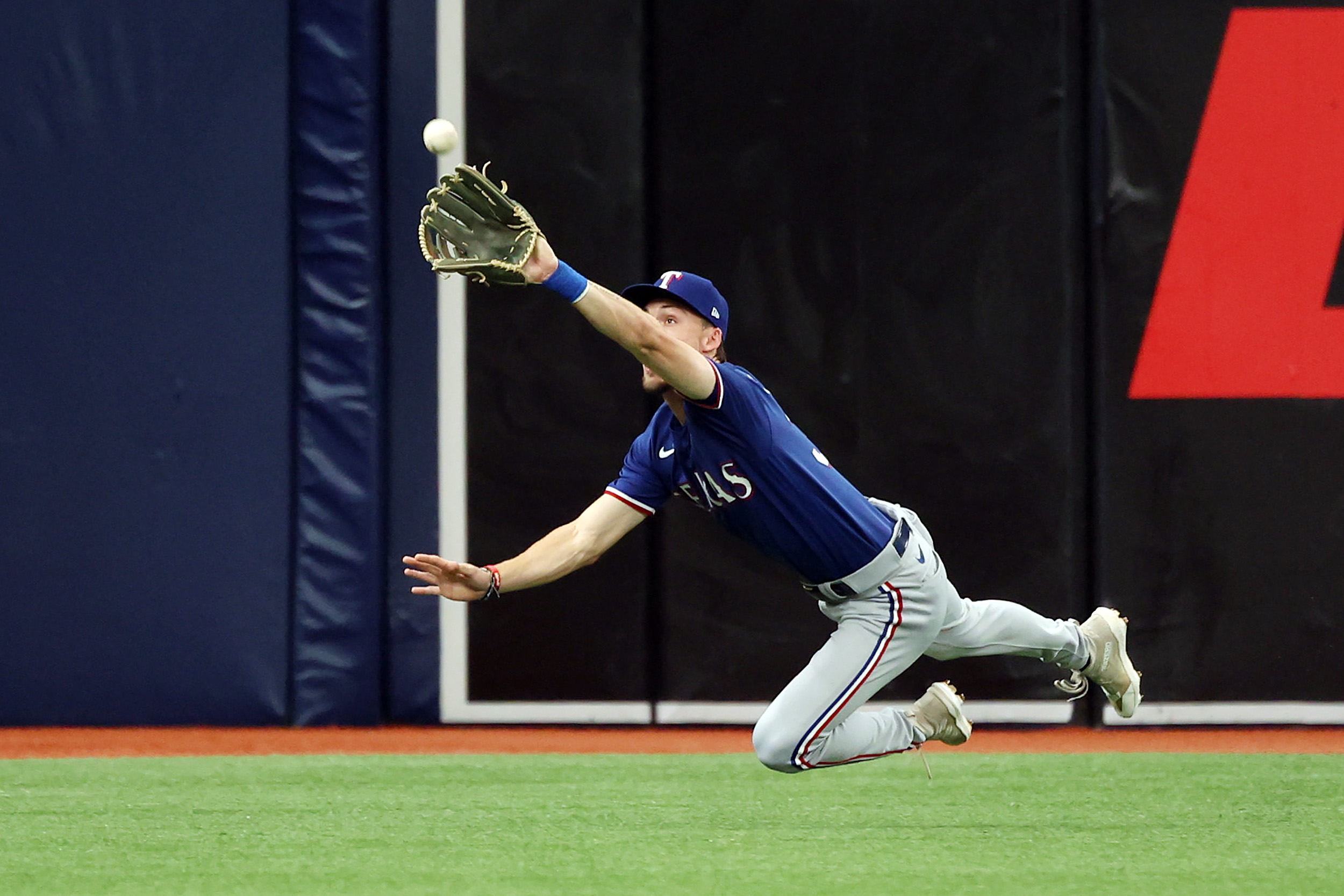 Texas Rangers left fielder Evan Carter catches a fly ball hit by Tampa Bay Rays third baseman Isaac Paredes in the first inning during Game 1 of the AL Wild Card series on Oct. 3 at Tropicana Field.
