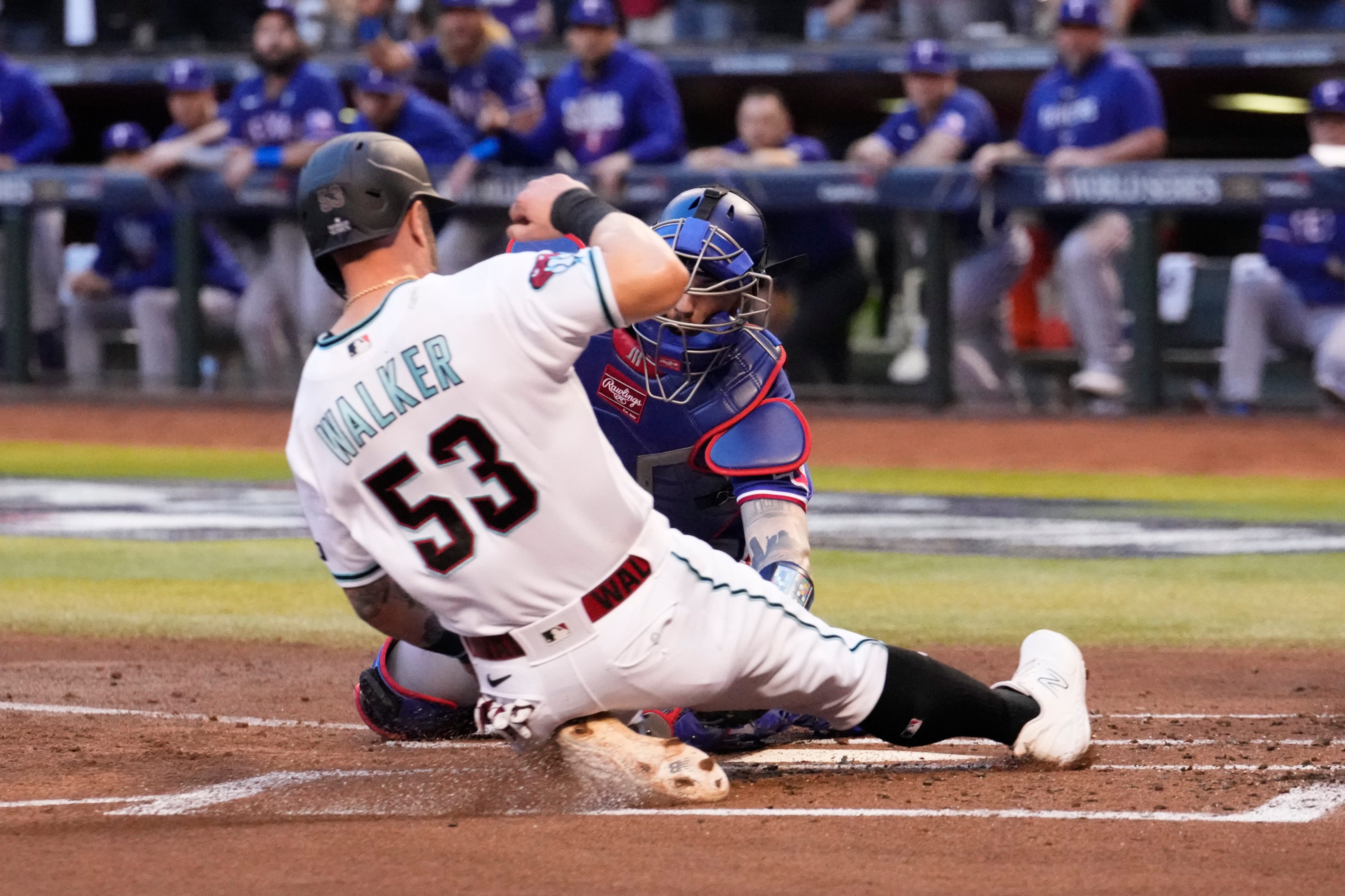 Arizona Diamondbacks first baseman Christian Walker is tagged out at home plate by Texas Rangers catcher Jonah Heim during the second inning in Game 3 of the World Series at Chase Field.