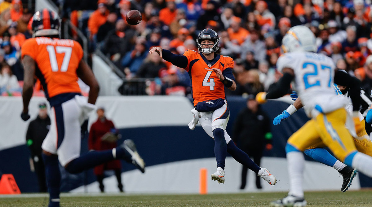 Jarrett Stidham leaps to throw a pass in his first start for the Broncos.