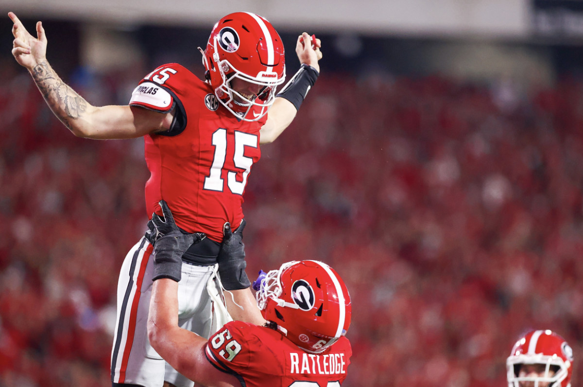 Georgia quarterback Carson Beck (15) is hoisted into the air by Georgia offensive guard Tate Ratledge (69) after scoring a touchdown versus UAB on Sept. 23, 2023 (Tony Walsh / UGAAA). 