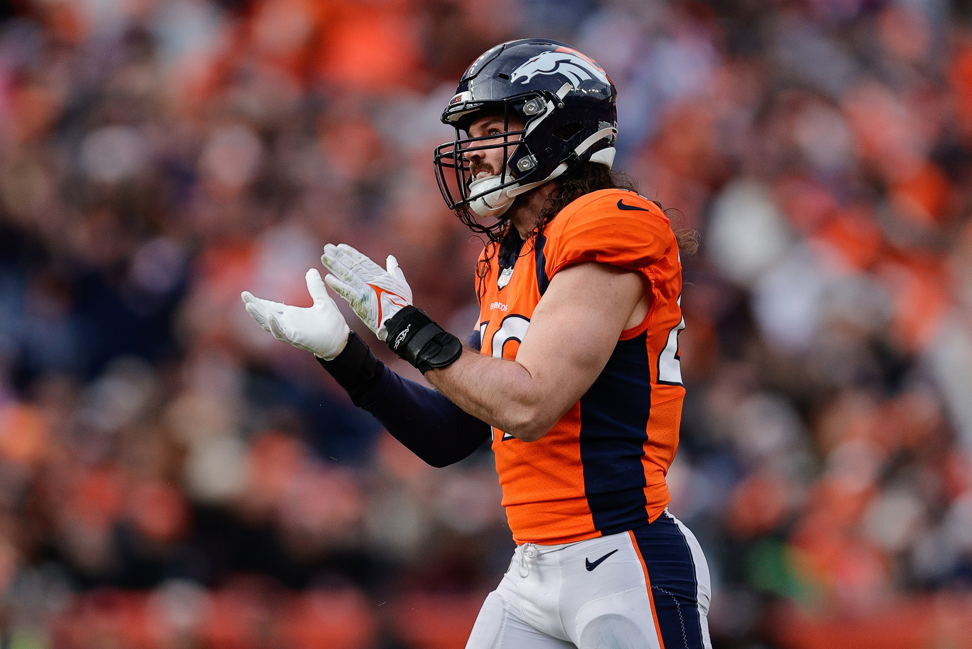 Denver Broncos linebacker Alex Singleton (49) reacts after a play in the second quarter against the Los Angeles Chargers at Empower Field at Mile High.