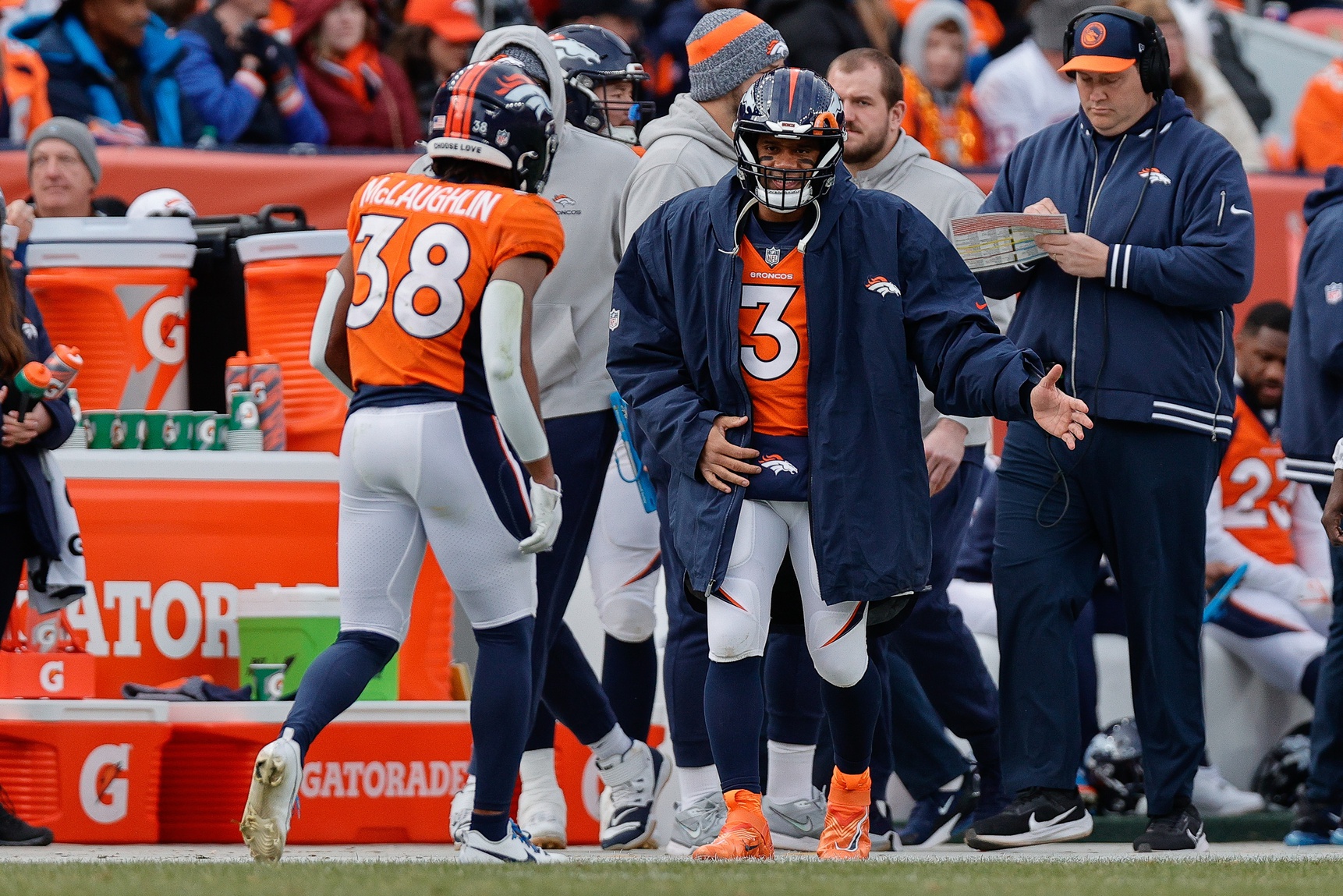 Denver Broncos quarterback Russell Wilson (3) reacts with running back Jaleel McLaughlin (38) after a play in the second quarter against the Los Angeles Chargers at Empower Field at Mile High.
