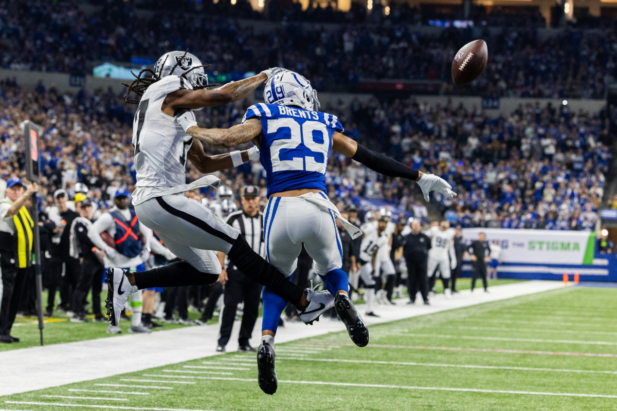 Dec 31, 2023; Indianapolis, Indiana, USA; Indianapolis Colts cornerback JuJu Brents (29) breaks up a pass to Las Vegas Raiders wide receiver Davante Adams (17) in the second half at Lucas Oil Stadium. Mandatory Credit: Trevor Ruszkowski-USA TODAY Sports