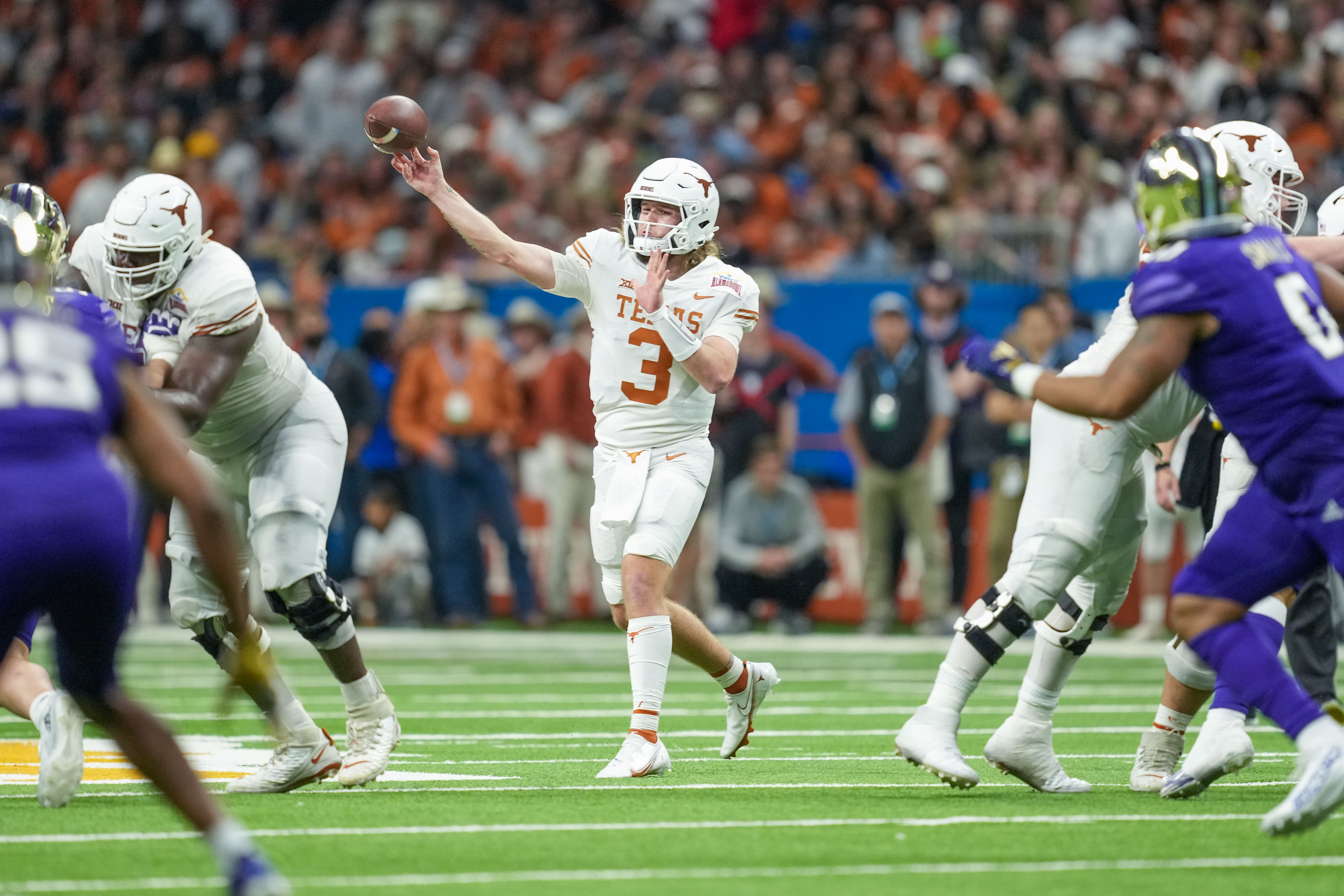 Dec 29, 2022; San Antonio, Texas, USA; Texas Longhorns quarterback Quinn Ewers (3) throws a pass in the 2022 Alamo Bowl against the Washington Huskies at the Alamodome. 
