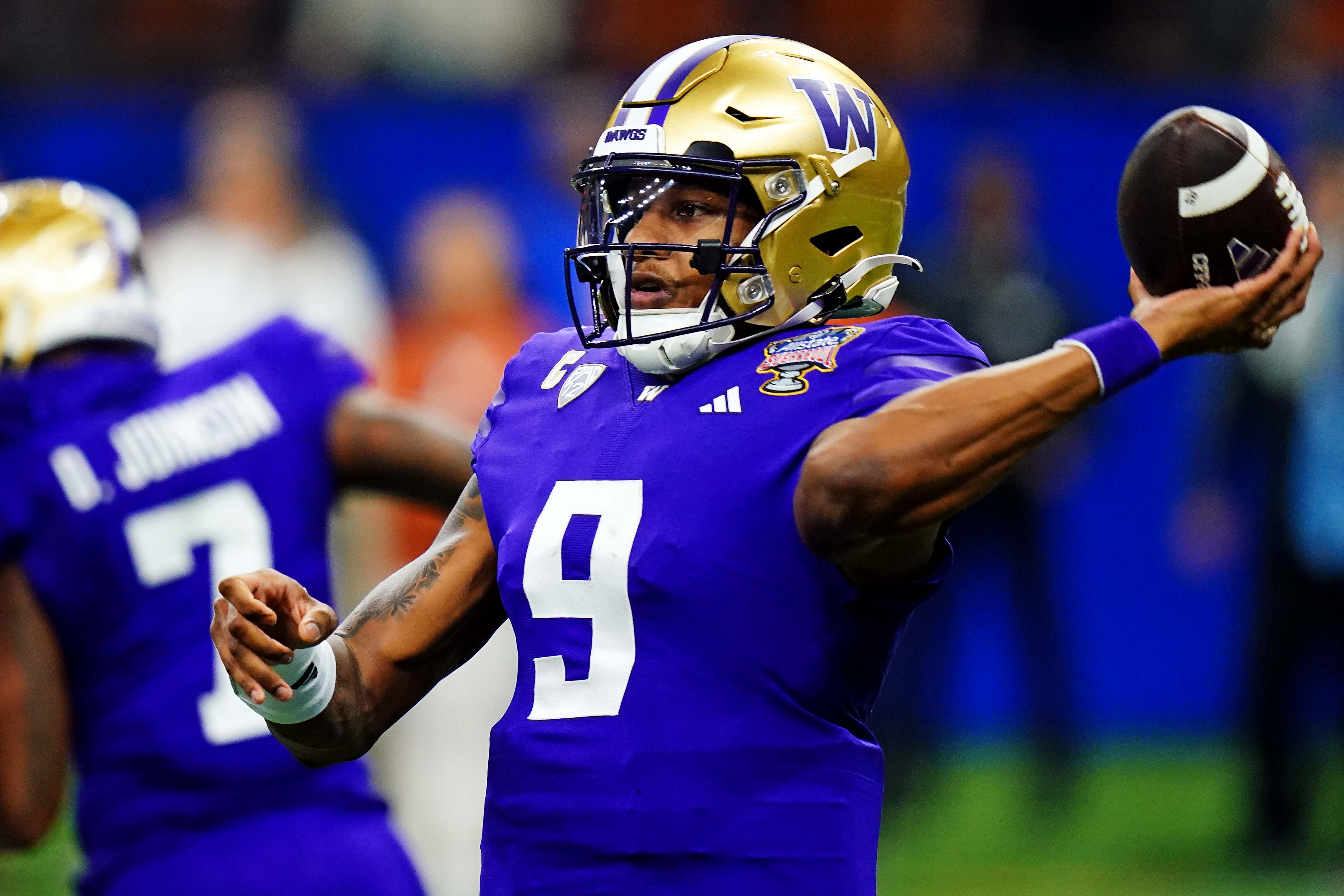 Washington Huskies quarterback Michael Penix Jr. throws a pass during the first quarter against the Texas Longhorns in the 2024 Sugar Bowl College Football Playoff semifinal game.