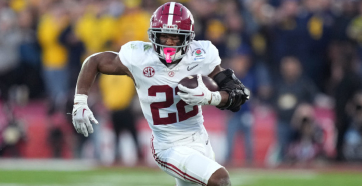 Alabama Crimson Tide running back Justice Haynes on a rushing attempt during a college football game in the SEC.