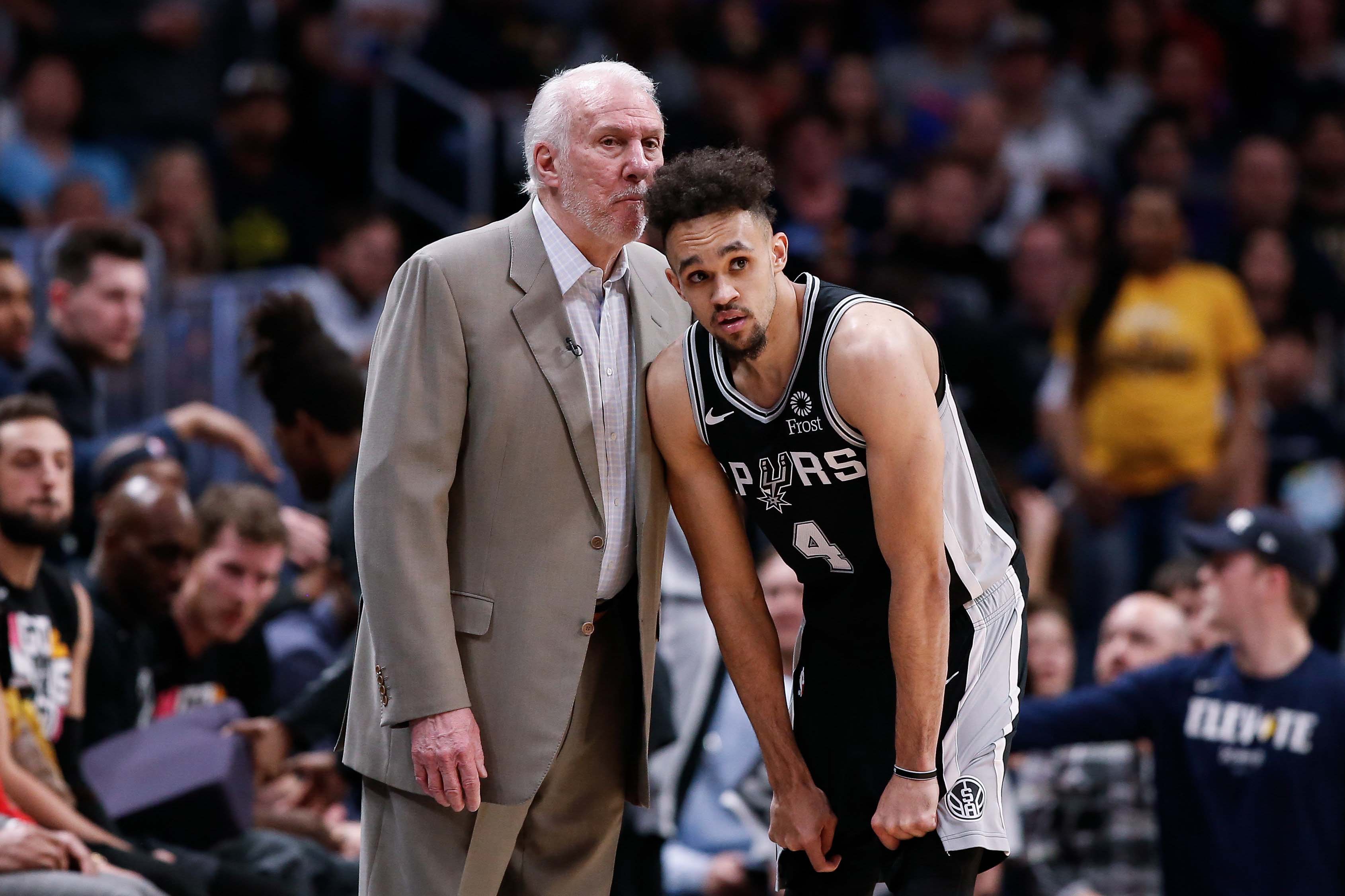 Apr 16, 2019; Denver, CO, USA; San Antonio Spurs head coach Gregg Popovich talks with guard Derrick White (4) in the second quarter against the Denver Nuggets in game two of the first round of the 2019 NBA Playoffs at the Pepsi Center.