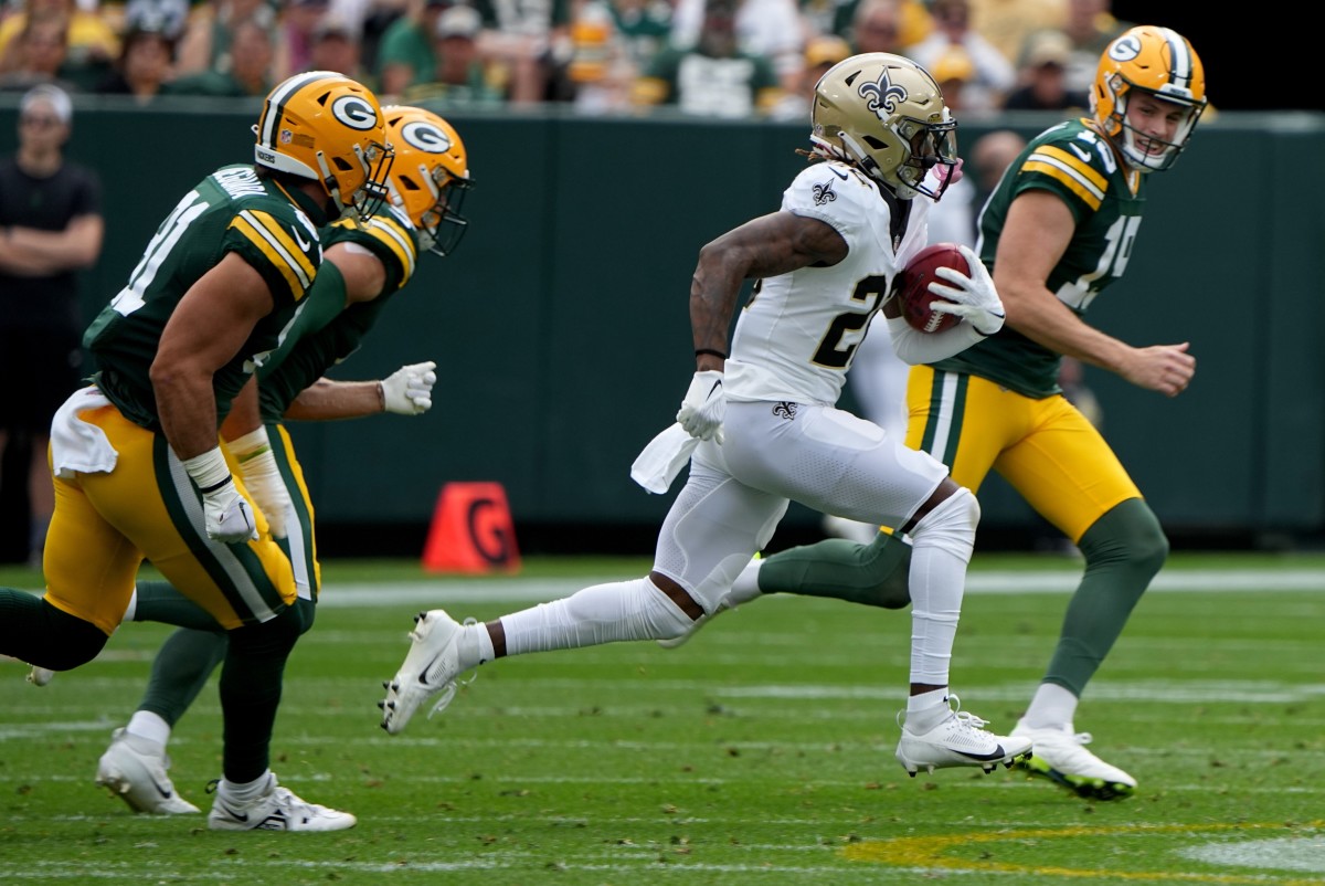 New Orleans Saints wide receiver Rashid Shaheed (22) runs past Green Bay Packers punter Daniel Whelan (19) to score a touchdown on a punt return. Mandatory Credit: Mark Hoffman-USA TODAY