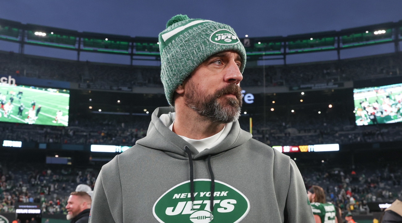 New York Jets quarterback Aaron Rodgers in a team hoodie during a 2023 game.