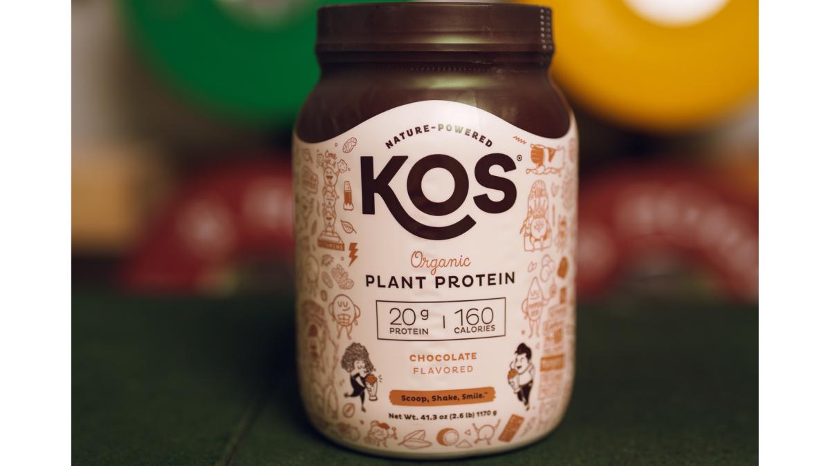 KOS Plant Protein brown and white container with brown writing, one of our picks for the best pea protein