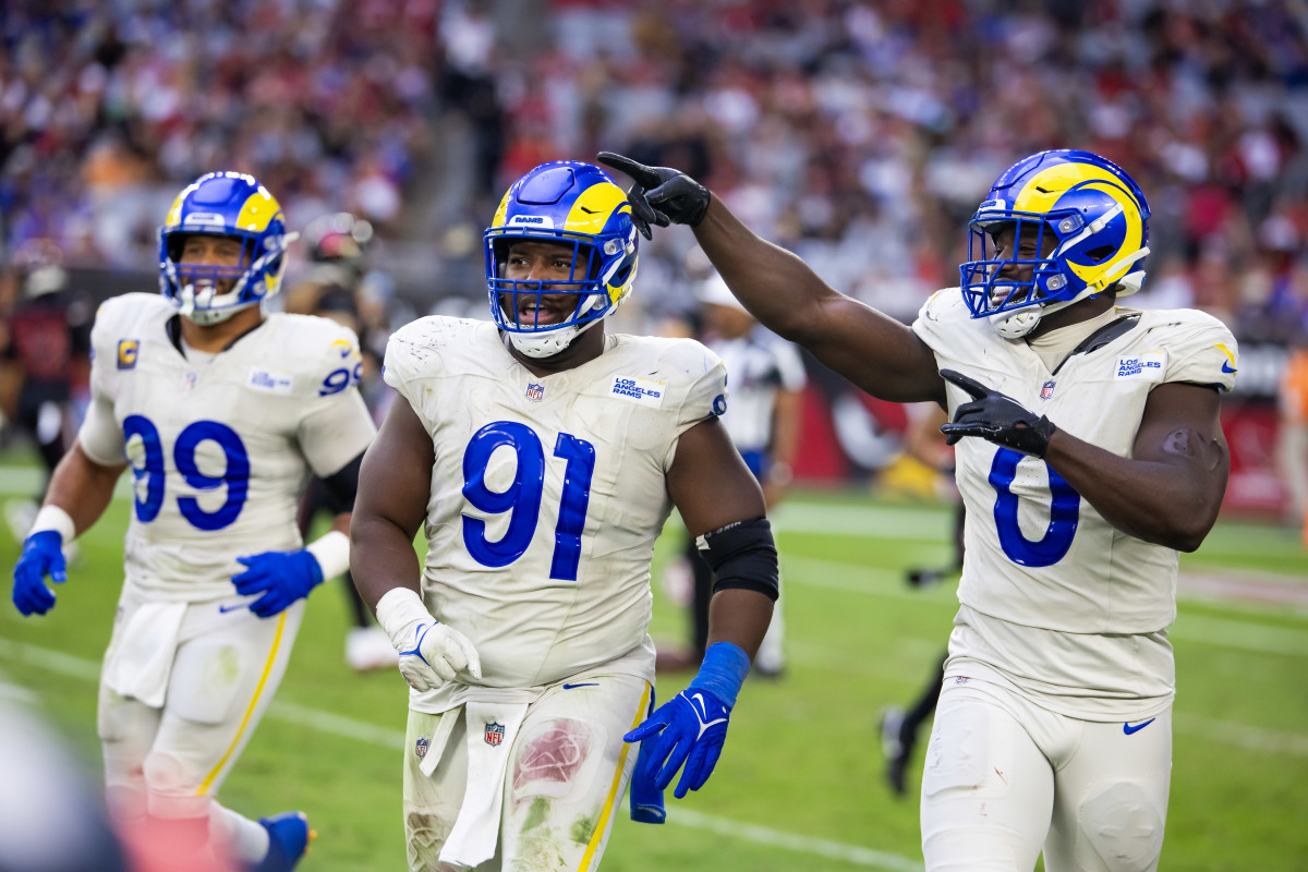 Nov 26, 2023; Glendale, Arizona, USA; Los Angeles Rams defensive tackle Kobie Turner (91) with linebacker Byron Young (0) and defensive tackle Aaron Donald (99) against the Arizona Cardinals at State Farm Stadium.