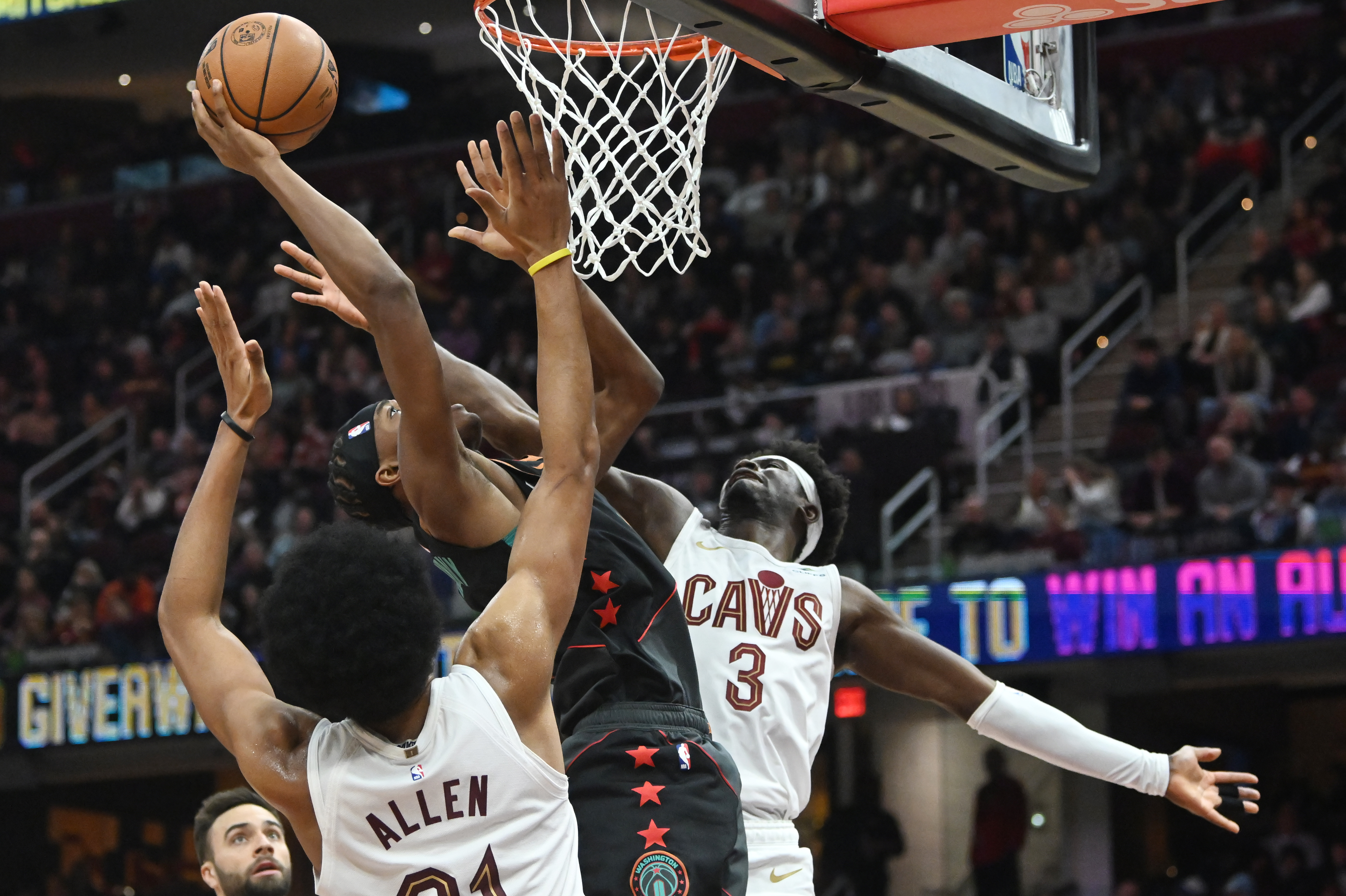 Jan 5, 2024; Cleveland, Ohio, USA; Cleveland Cavaliers center Jarrett Allen (31) and guard Caris LeVert (3) go for a rebound against Washington Wizards guard Bilal Coulibaly (0) during the second half at Rocket Mortgage FieldHouse.