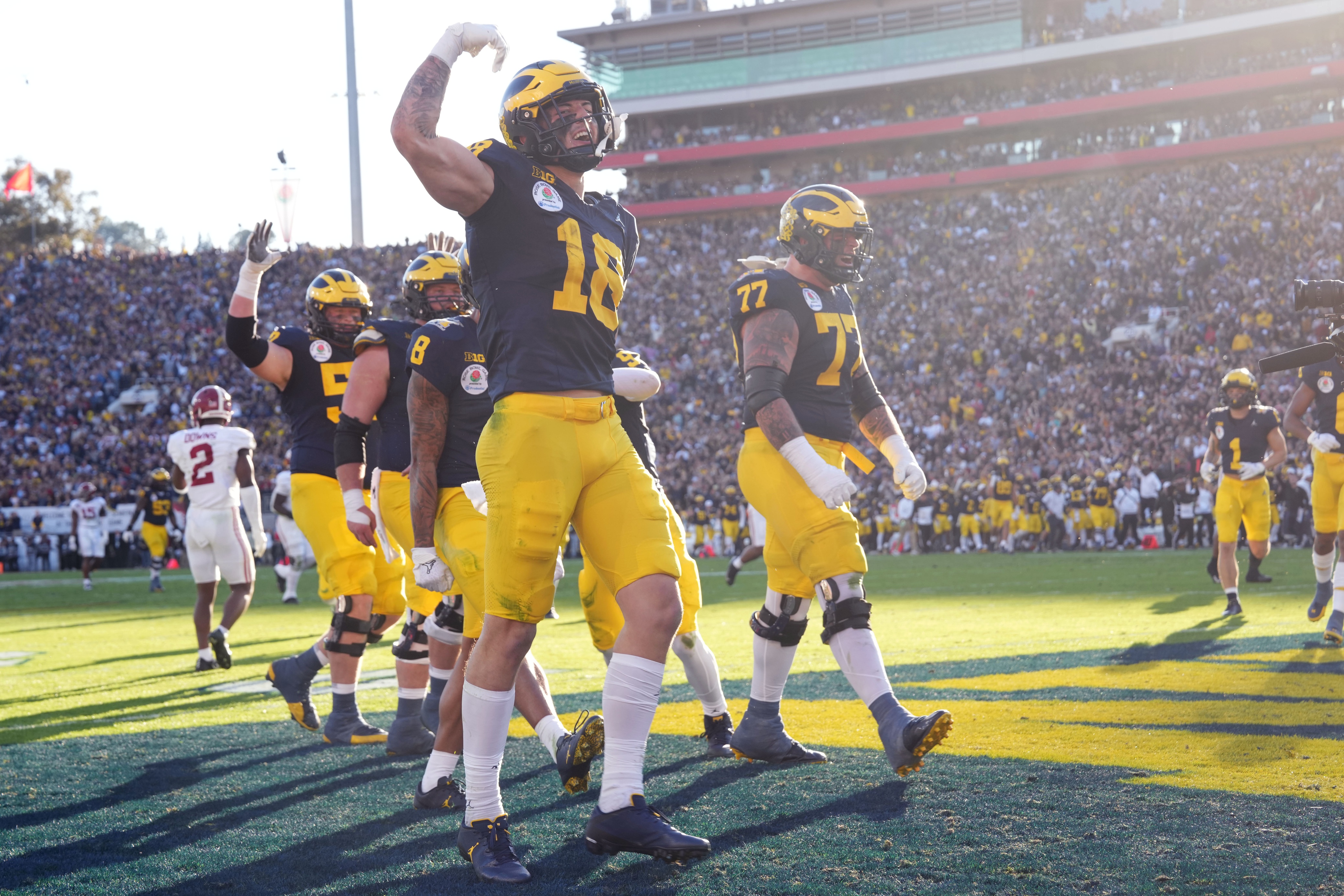 Michigan Wolverines tight end Colston Loveland (18) and offensive lineman Trevor Keegan (77) react after a touchdown.