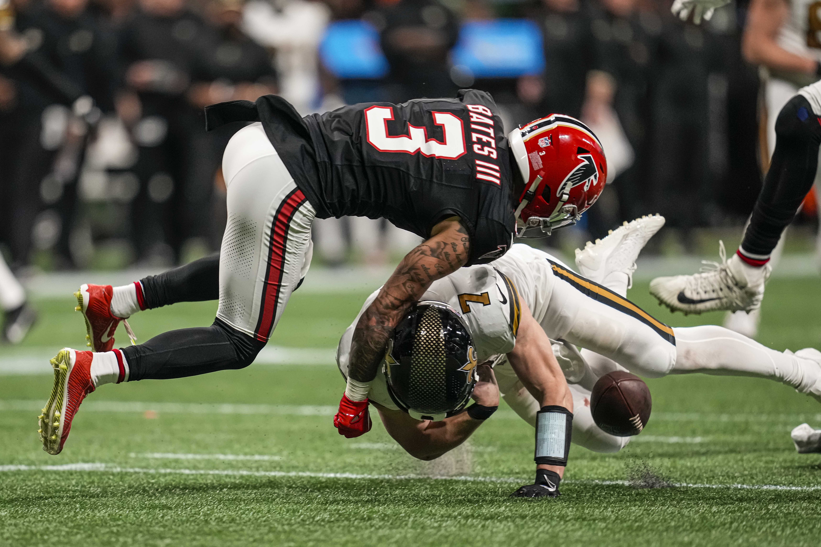 New Orleans Saints quarterback Taysom Hill (7) fumbles when hit by Atlanta Falcons safety Jessie Bates III (3). Mandatory Credit: Dale Zanine-USA TODAY Sports