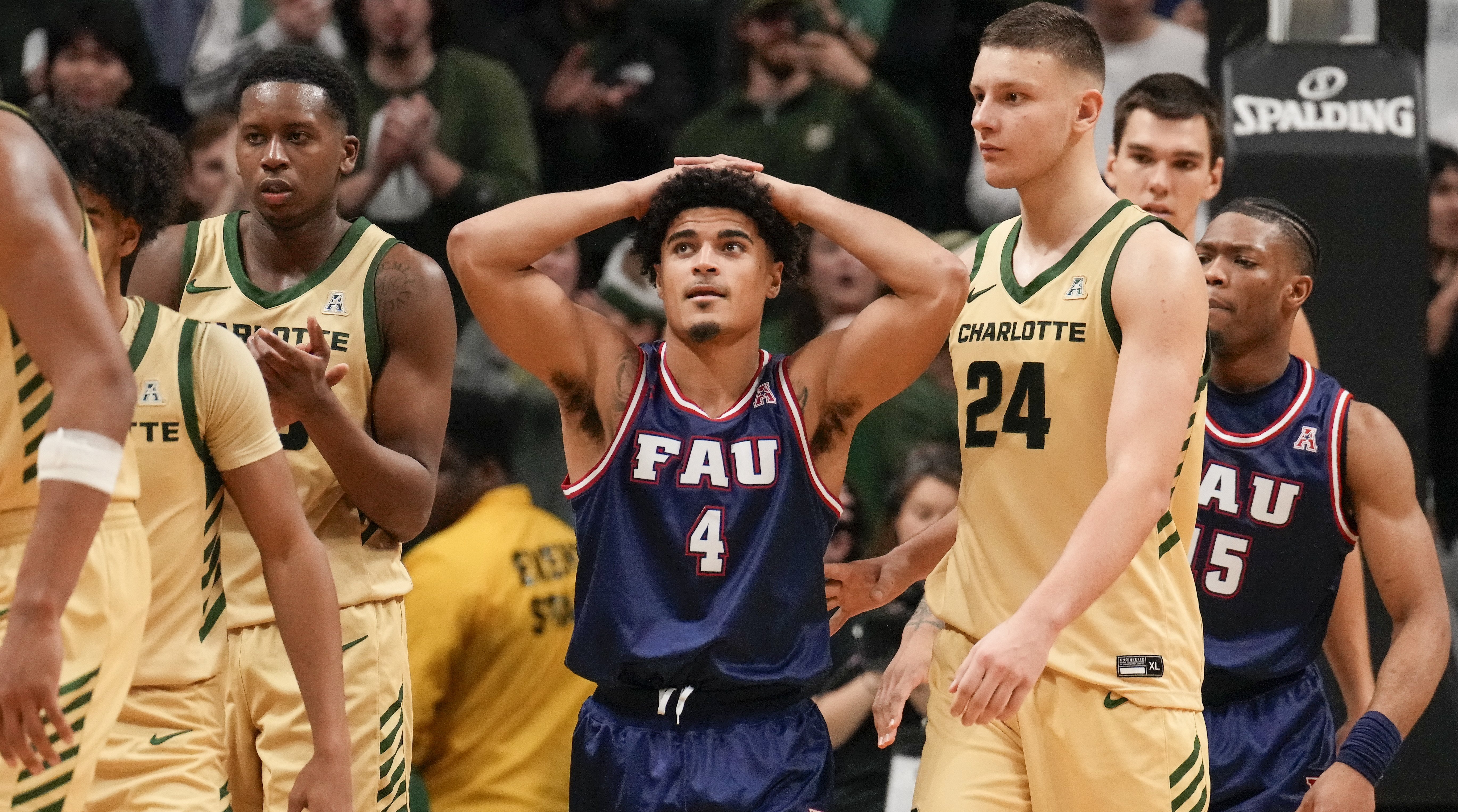 Florida Atlantic guard Bryan Greenlee, center, reacts to his foul that takes Charlotte  to the line for the winning free throws.