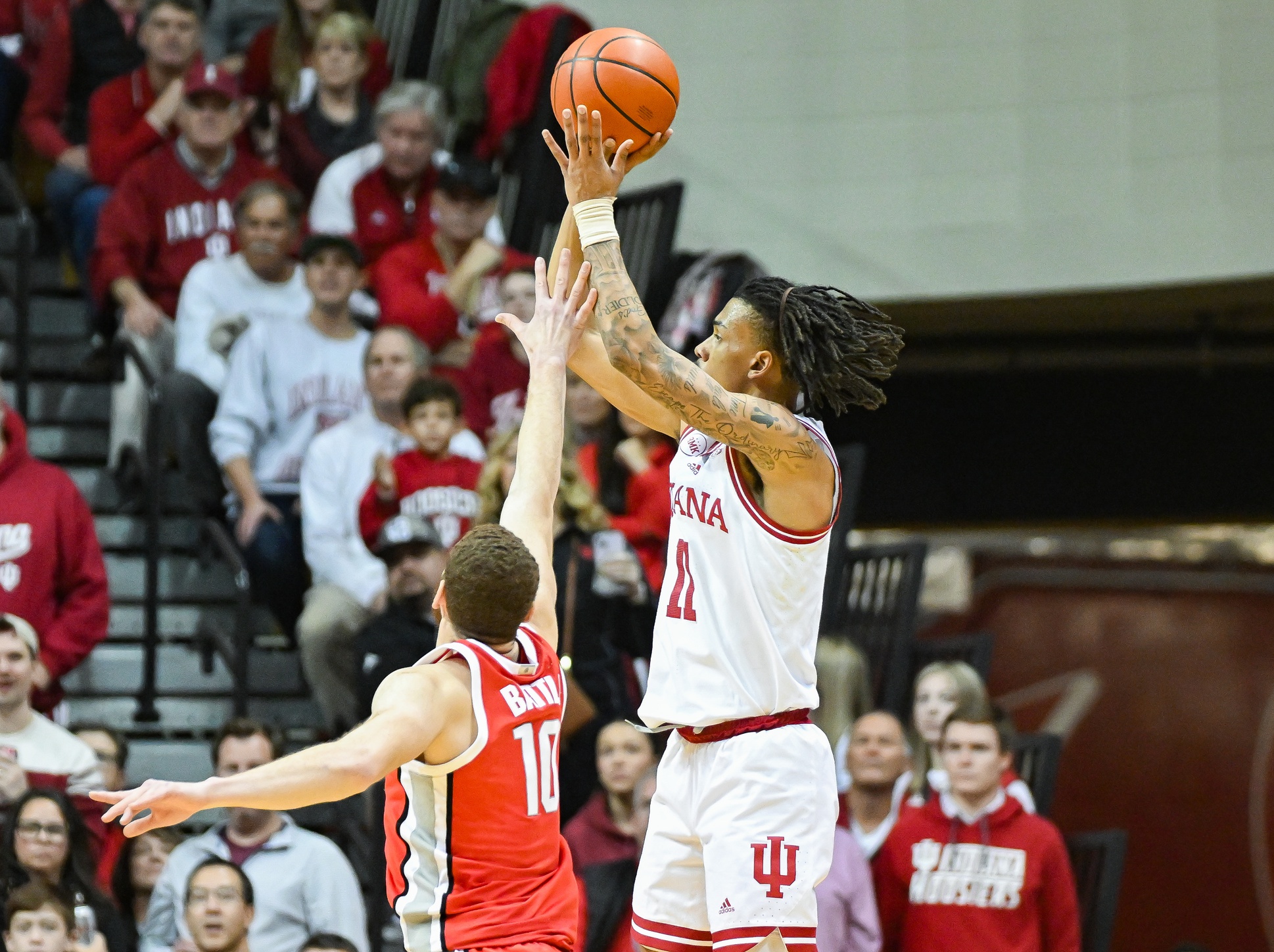 Indiana Hoosiers guard CJ Gunn (11) makes a three-point basket over Ohio State Buckeyes forward Jamison Battle (10) during the second half at Simon Skjodt Assembly Hall.