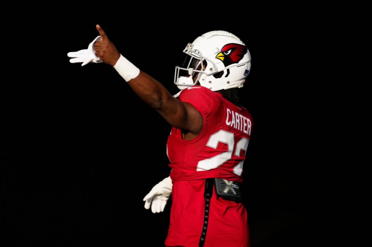 Arizona Cardinals running back Michael Carter (22) warms up before a game against the Chicago Bears at Soldier Field.