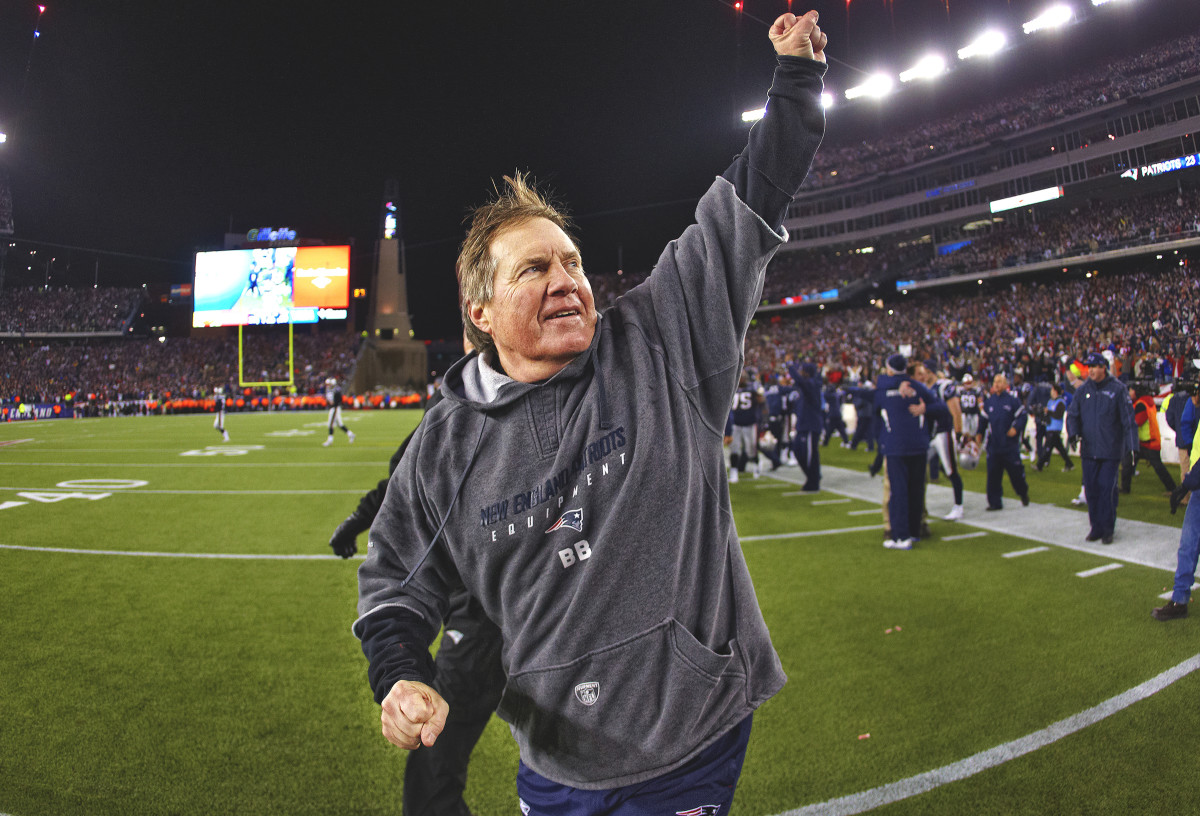 Bill Belichick walks off the field with his fist up