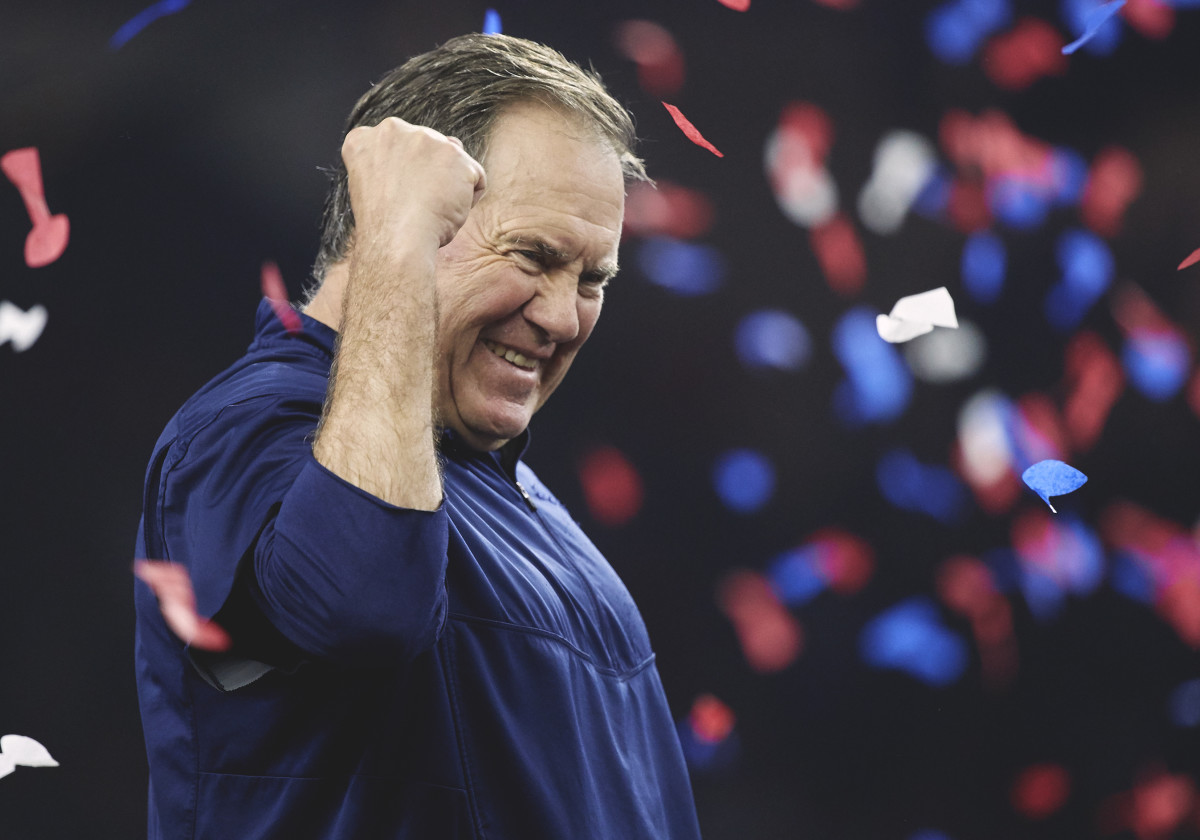 Bill Belichick pumps his fist as confetti falls behind him