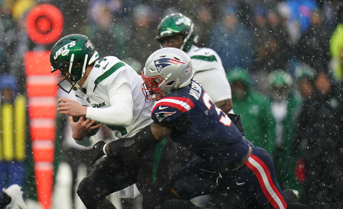 New York Jets quarterback Trevor Siemian (14) is sacked by New England Patriots linebacker Mack Wilson Sr. (3) in the first quarter at Gillette Stadium.