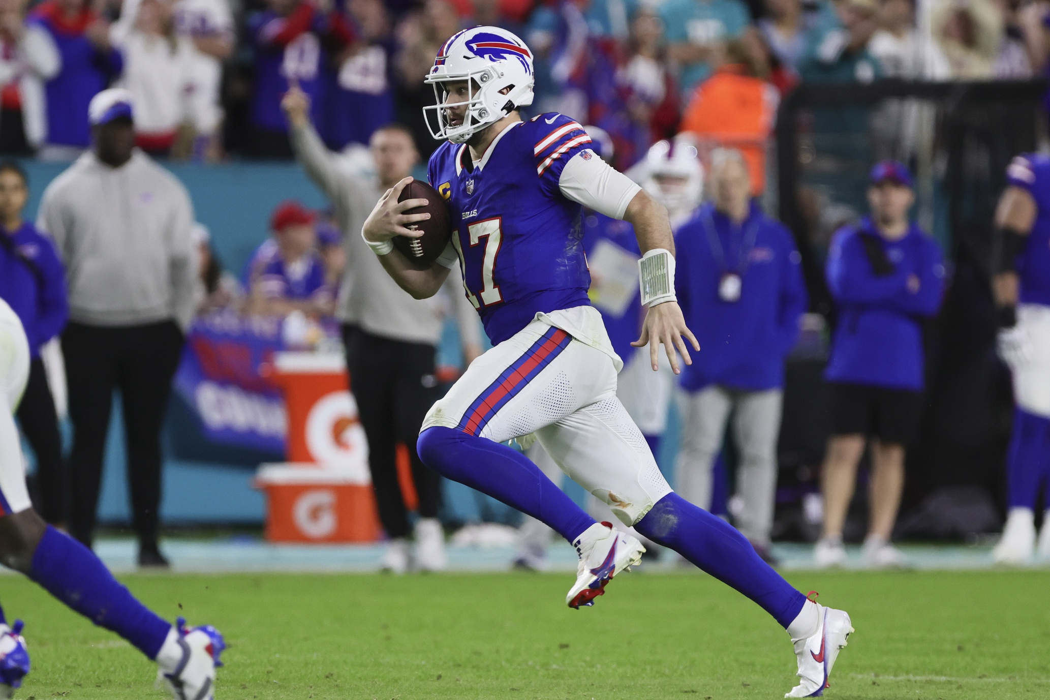 Buffalo Bills quarterback Josh Allen used his legs and his arms to lead Buffalo past Miami for the AFC East title in Week 18.