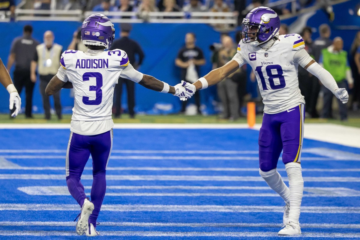 Jordan Addison shakes hands with Justin Jefferson standing in the Lions’ endzone