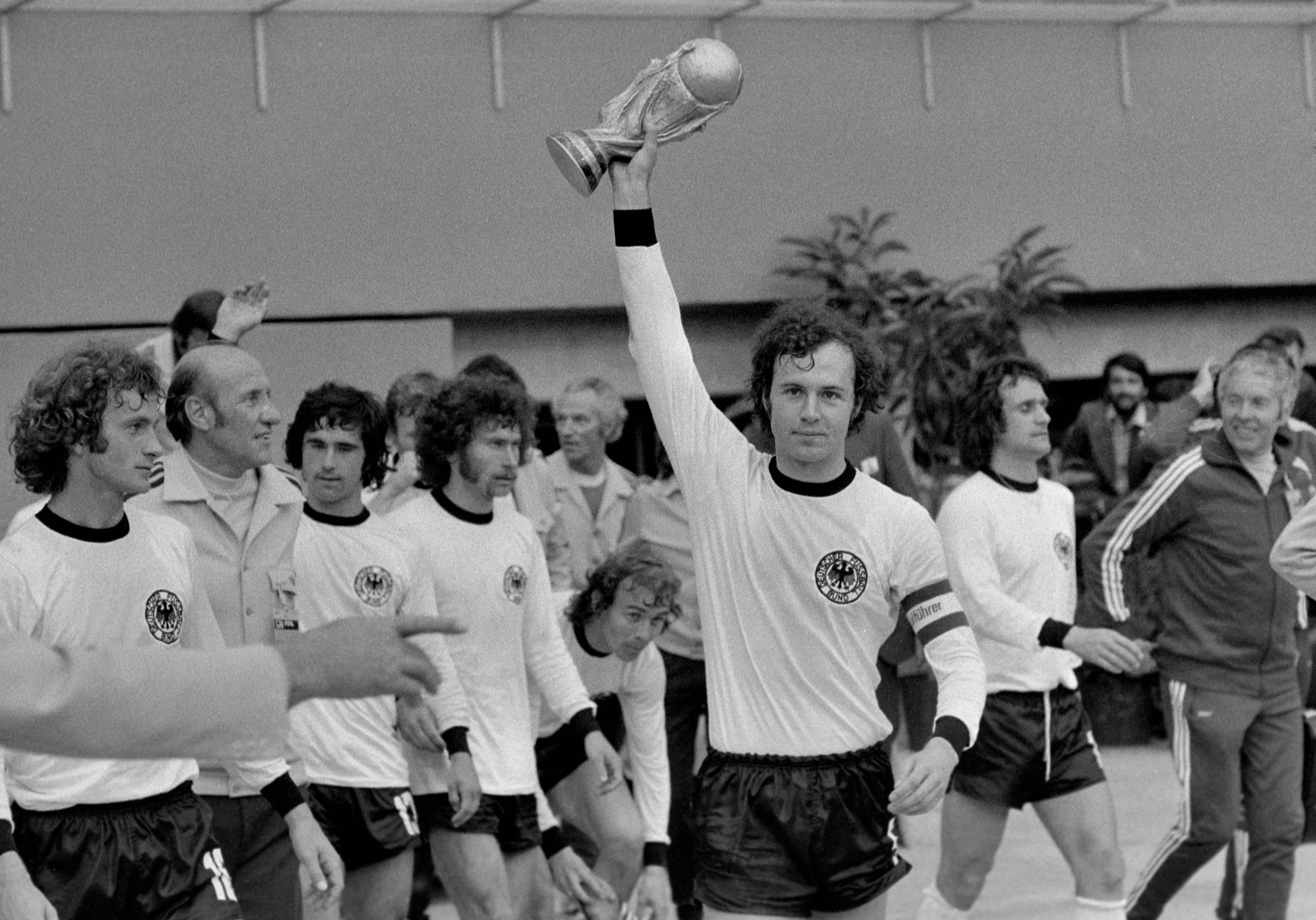 Germany captain Franz Beckenbauer pictured lifting the World Cup trophy in 1974