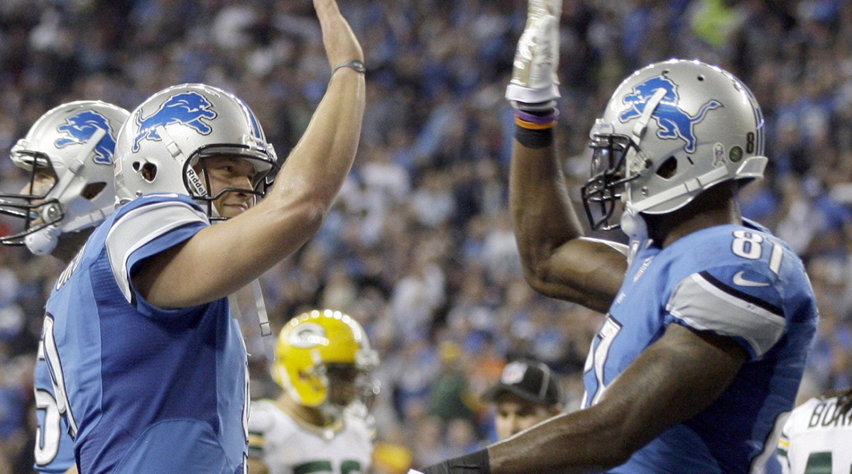 Detroit Lions quarterback Matthew Stafford high fives Calvin Johnson after they combined for a touchdown against the Green Bay Packers in the third quarter in Detroit, Sunday, November 18, 2012.