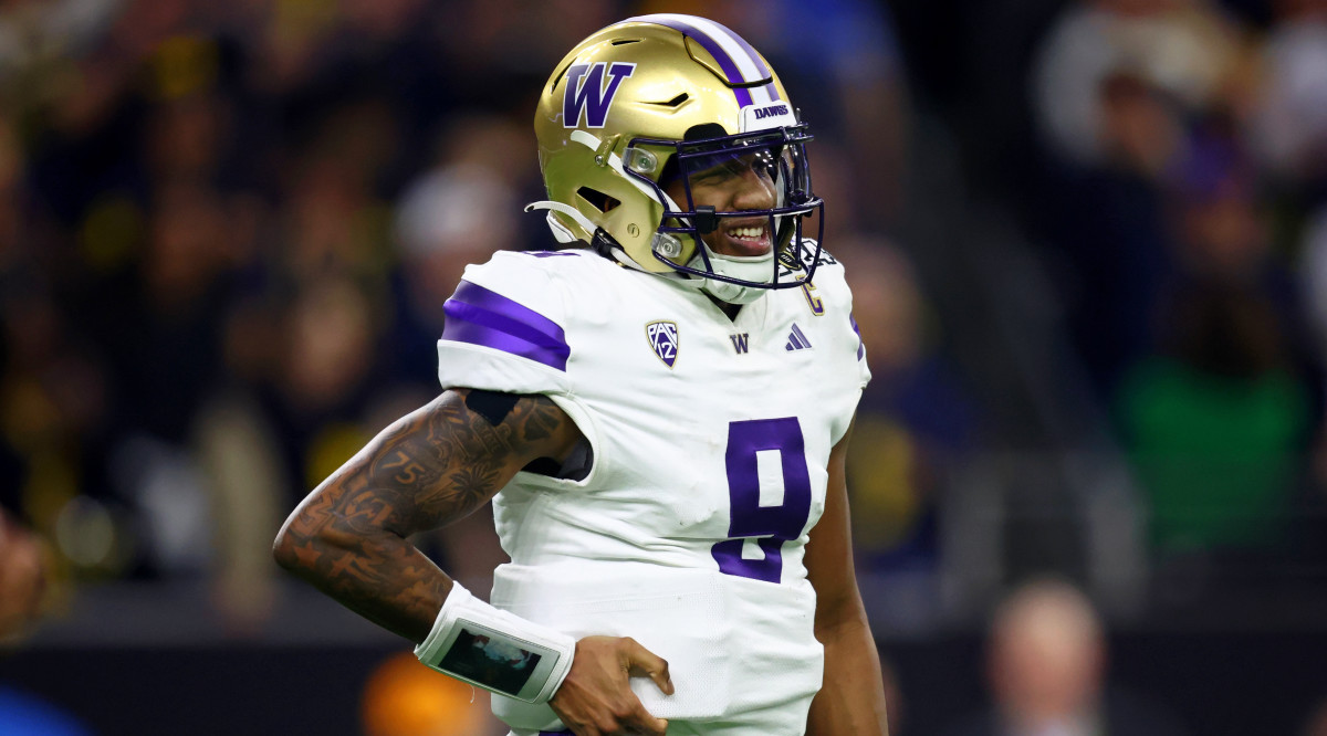 Washington QB Michael Penix Jr. grimaces in pain during CFP title game