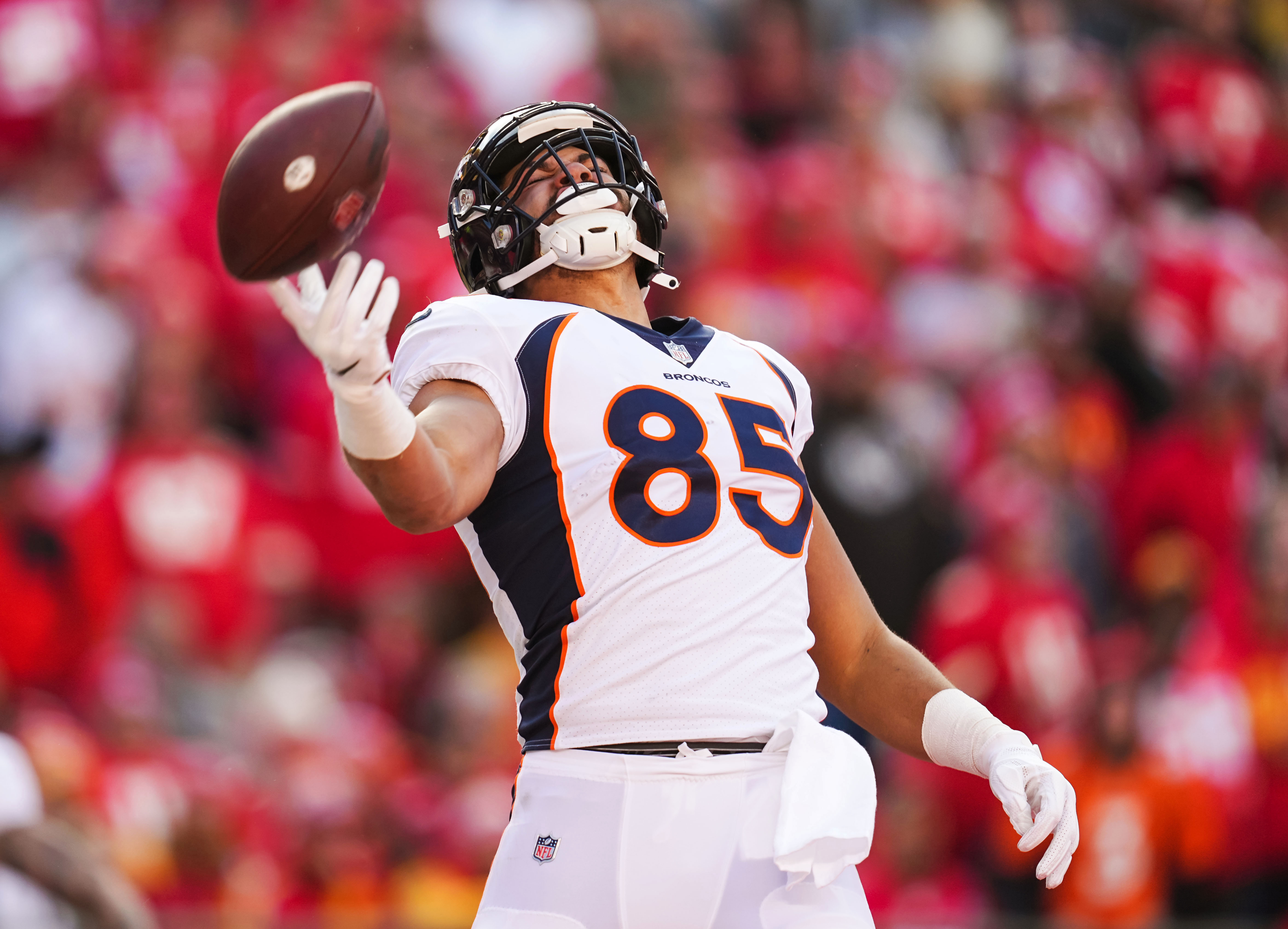 Denver Broncos tight end Albert Okwuegbunam (85) throws the ball after scoring a touchdown during the second half against the Kansas City Chiefs at GEHA Field at Arrowhead Stadium.